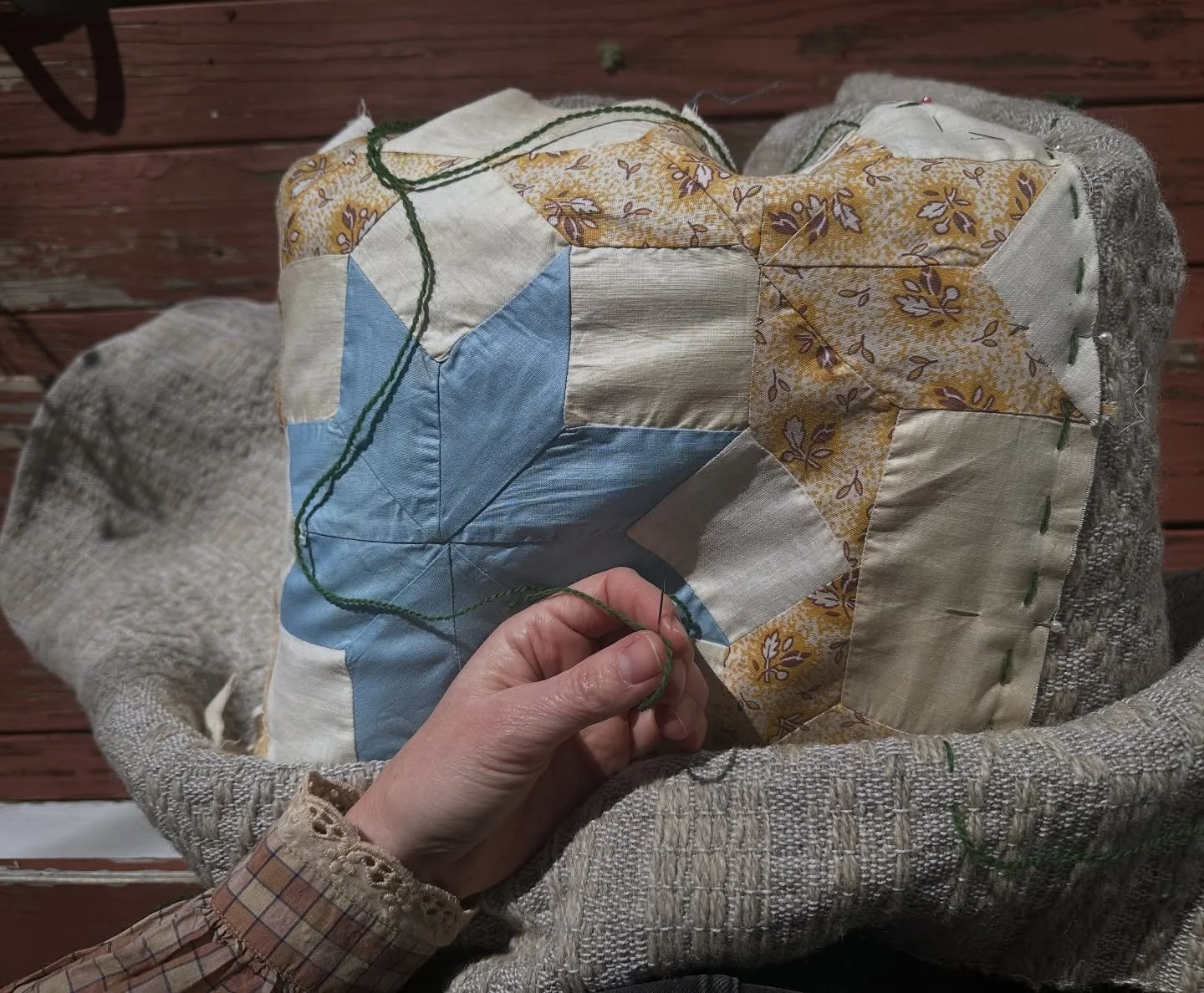 Stitching quilt blocks onto woven cloth.⭐️