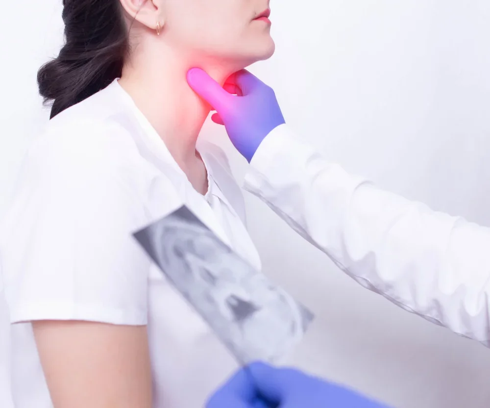 A medical professional assessing a patient’s throat for tonsillitis