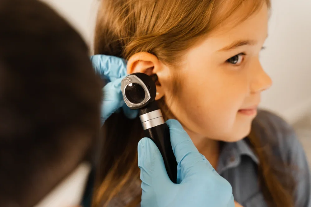 A child getting checked for an ear infection