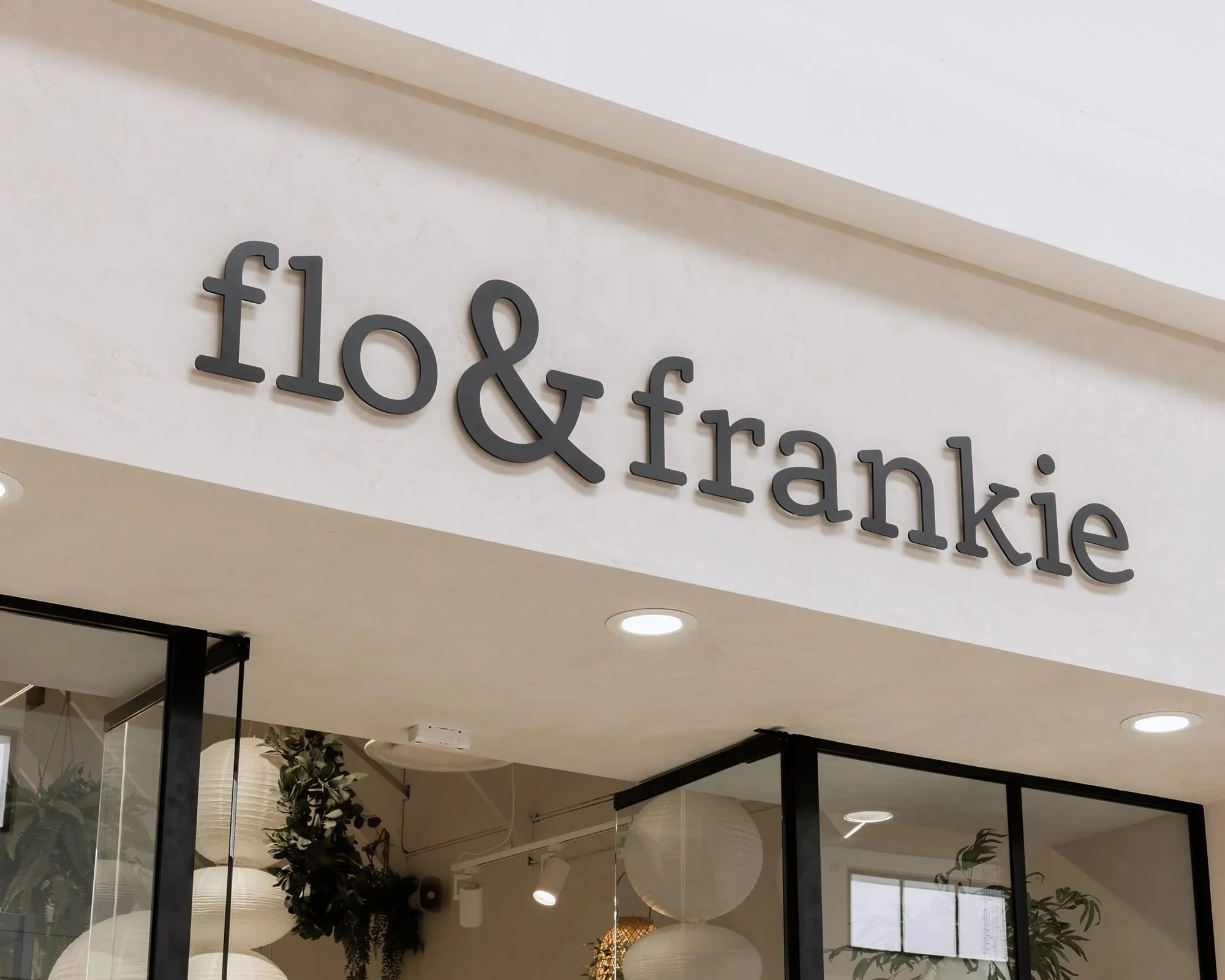 Sign in a shopping mall that reads 'food & drive' and 'make'.