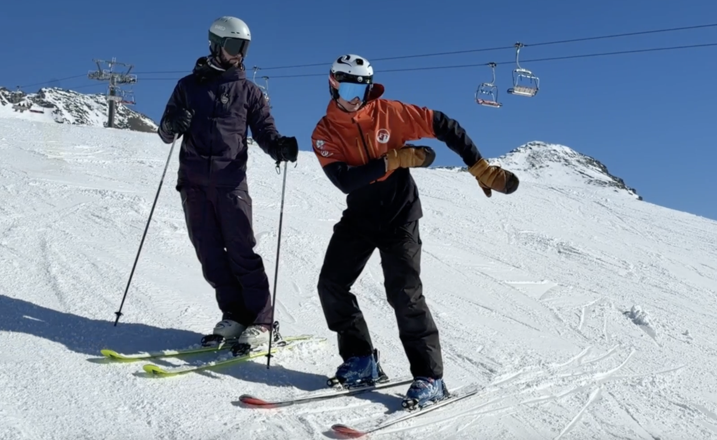 Adult ski coaching session focusing on carving technique at a ski camp