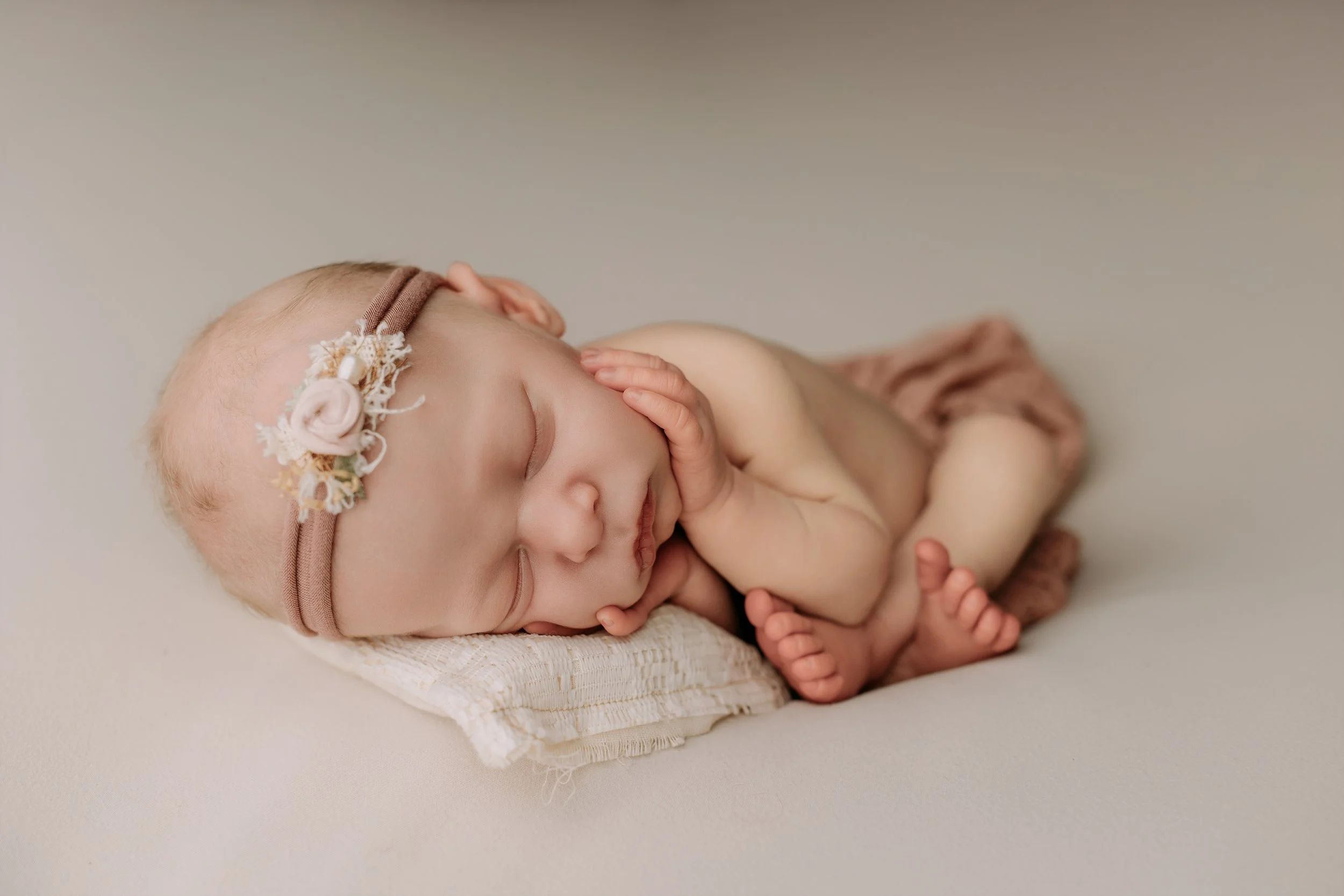 newborn-baby-girl-sleeping-side-pose-blush-wrap.jpg