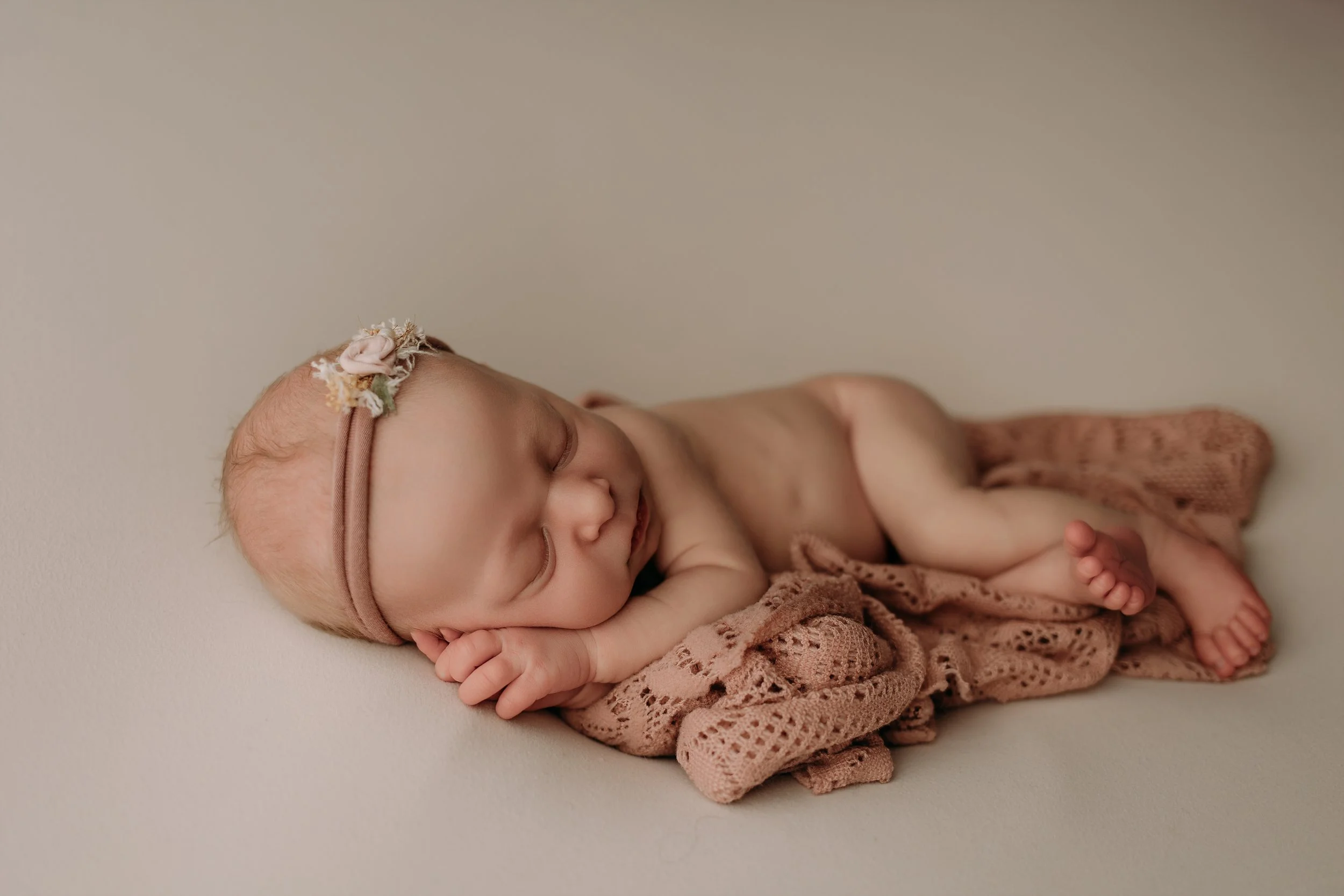 newborn-baby-girl-sleeping-side-pose-blush-wrap.jpg