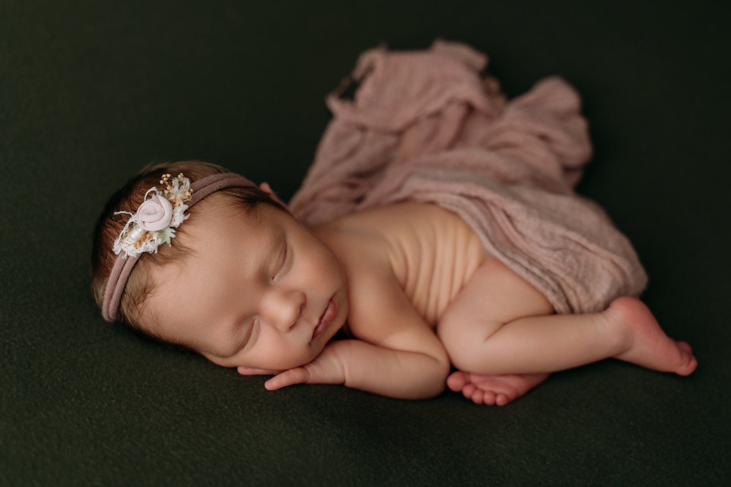 newborn-baby-photoshoot-posed-on-olive-green.jpg