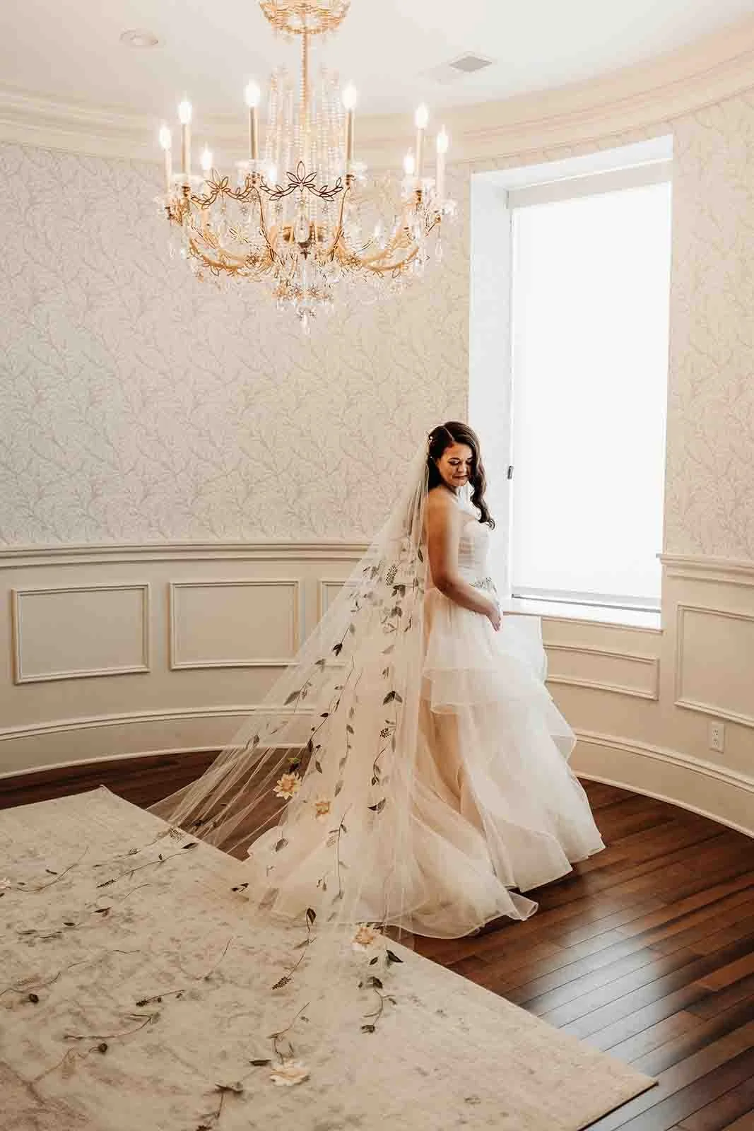 new bride posing in front of a window, wedding photography
