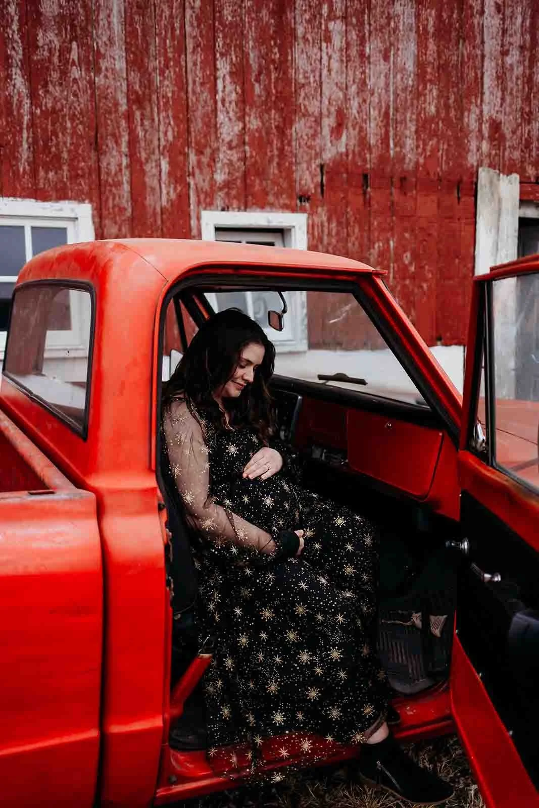 new mama holding her belly inside of a old truck, maternity photography