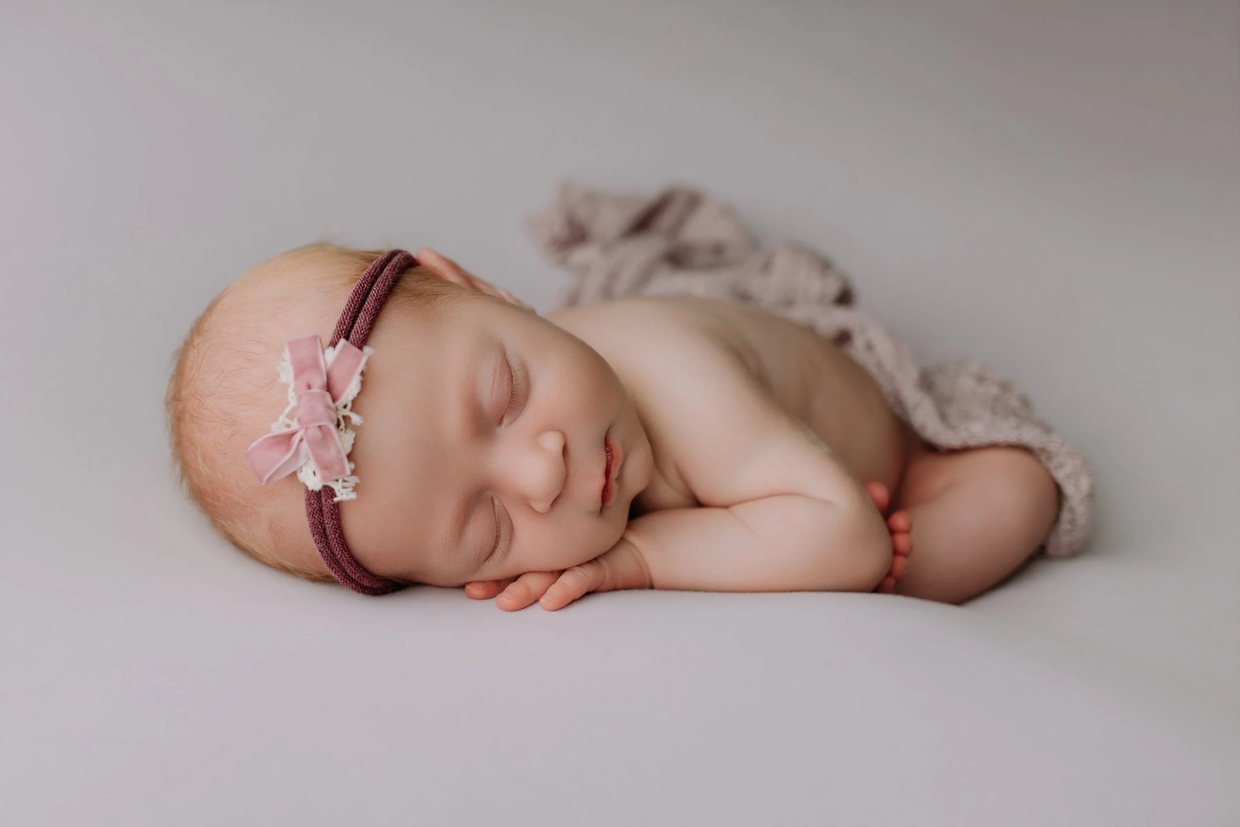 newborn-baby-girl-chin-on-hands-pose.jpg