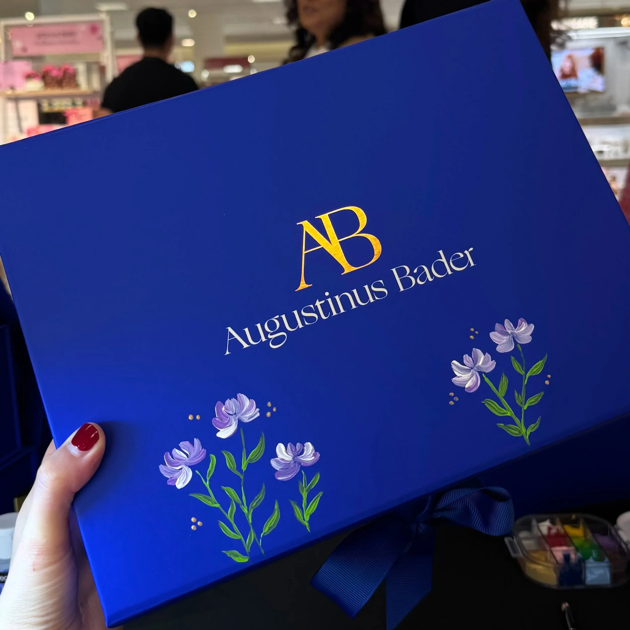 Hand painted florals on an Augustinus Bader box for a customer shopping at the Beauty Bash Nordstrom event - Santa Anita mall in Arcadia, CA 