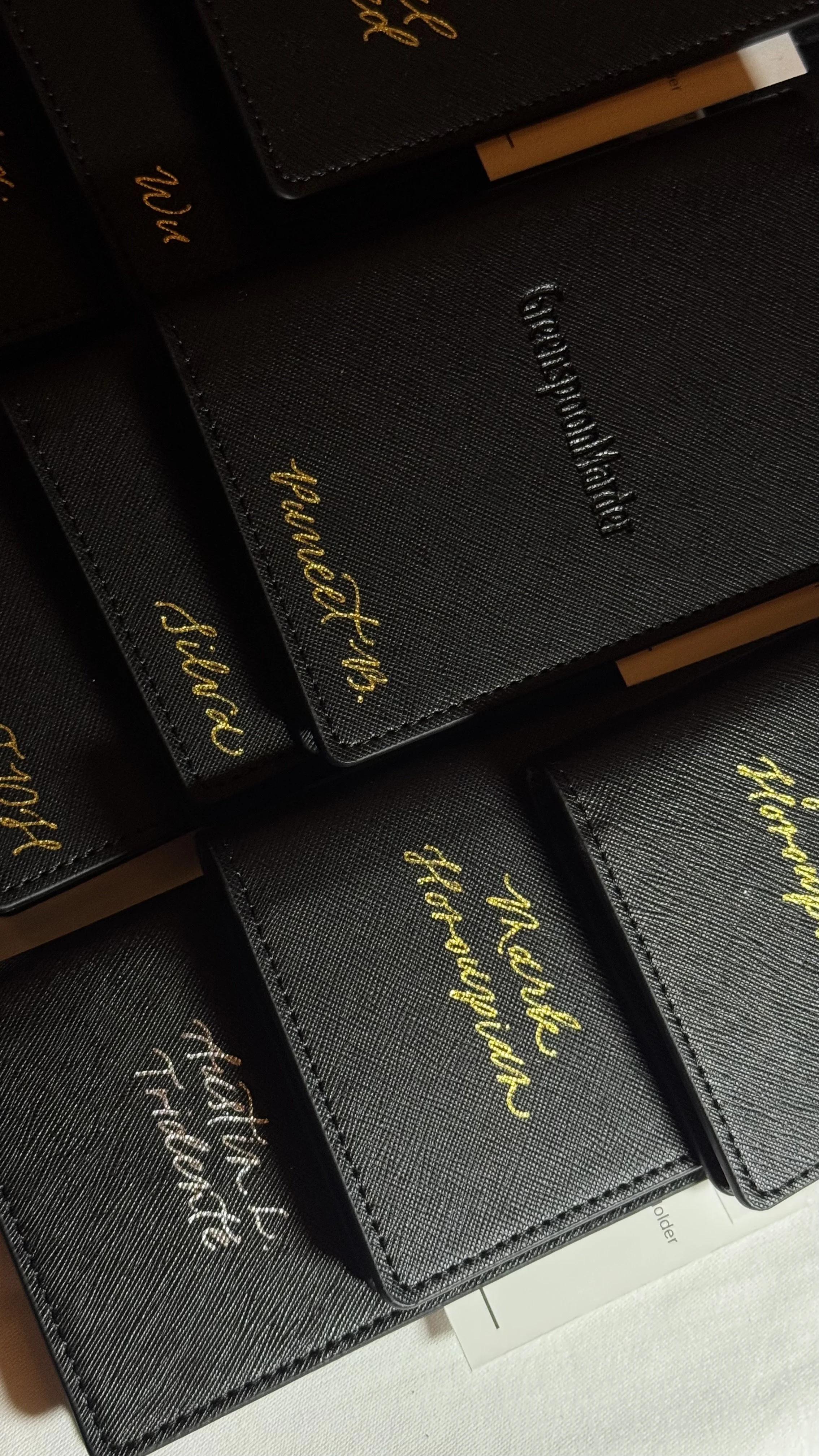 Hot foiling guest names on passport holders for Greenspoon Marder LLP at their holiday party in Beverly Hills, CA