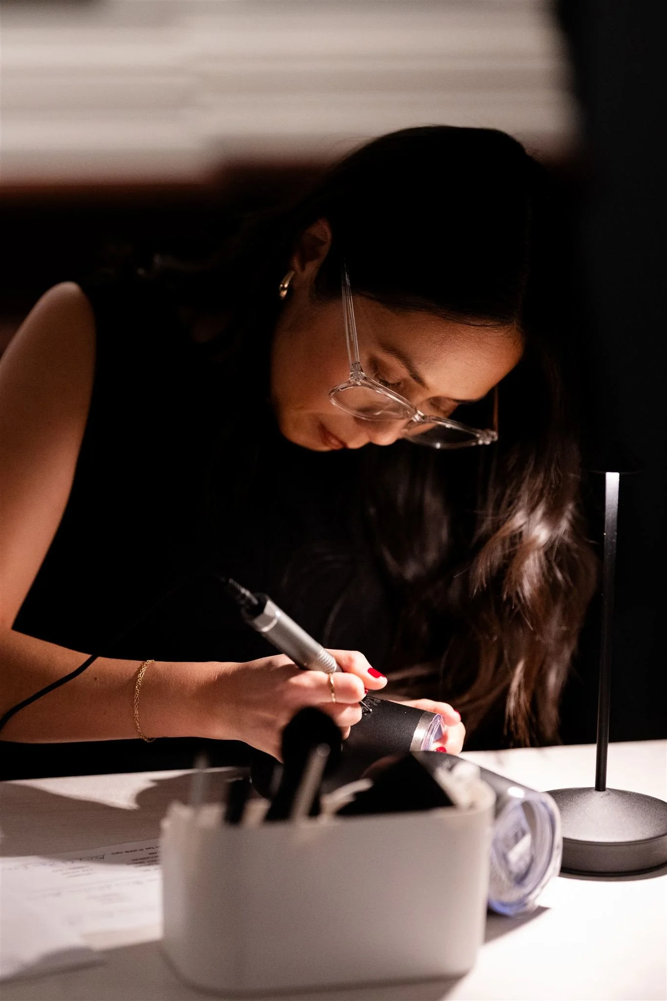 Engraving wine tumblers for guests at The Cheesecake Factory corporate holiday event in Westlake, CA