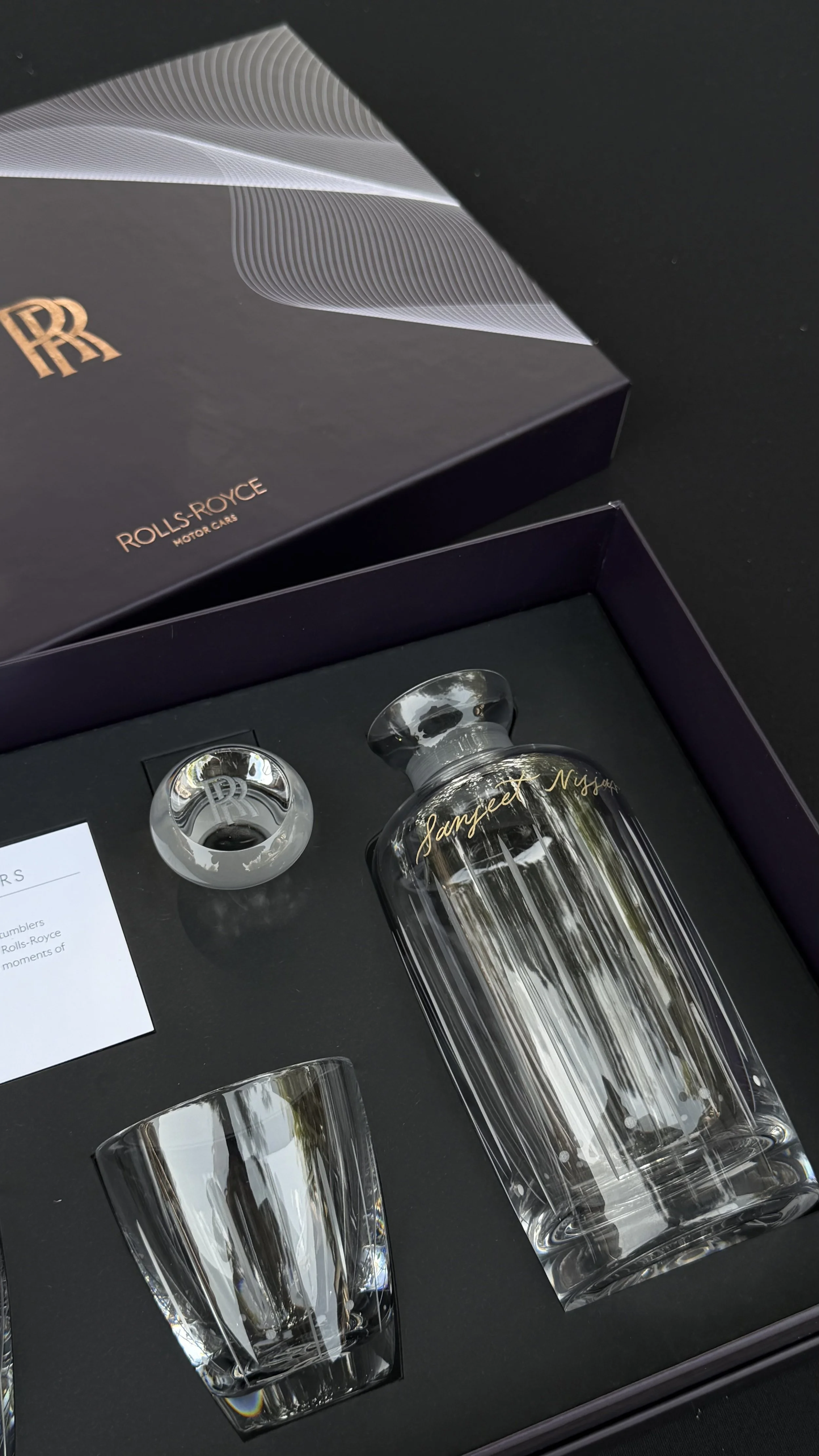 Hand engraved Rolls Royce decanter set at a private luxury car event