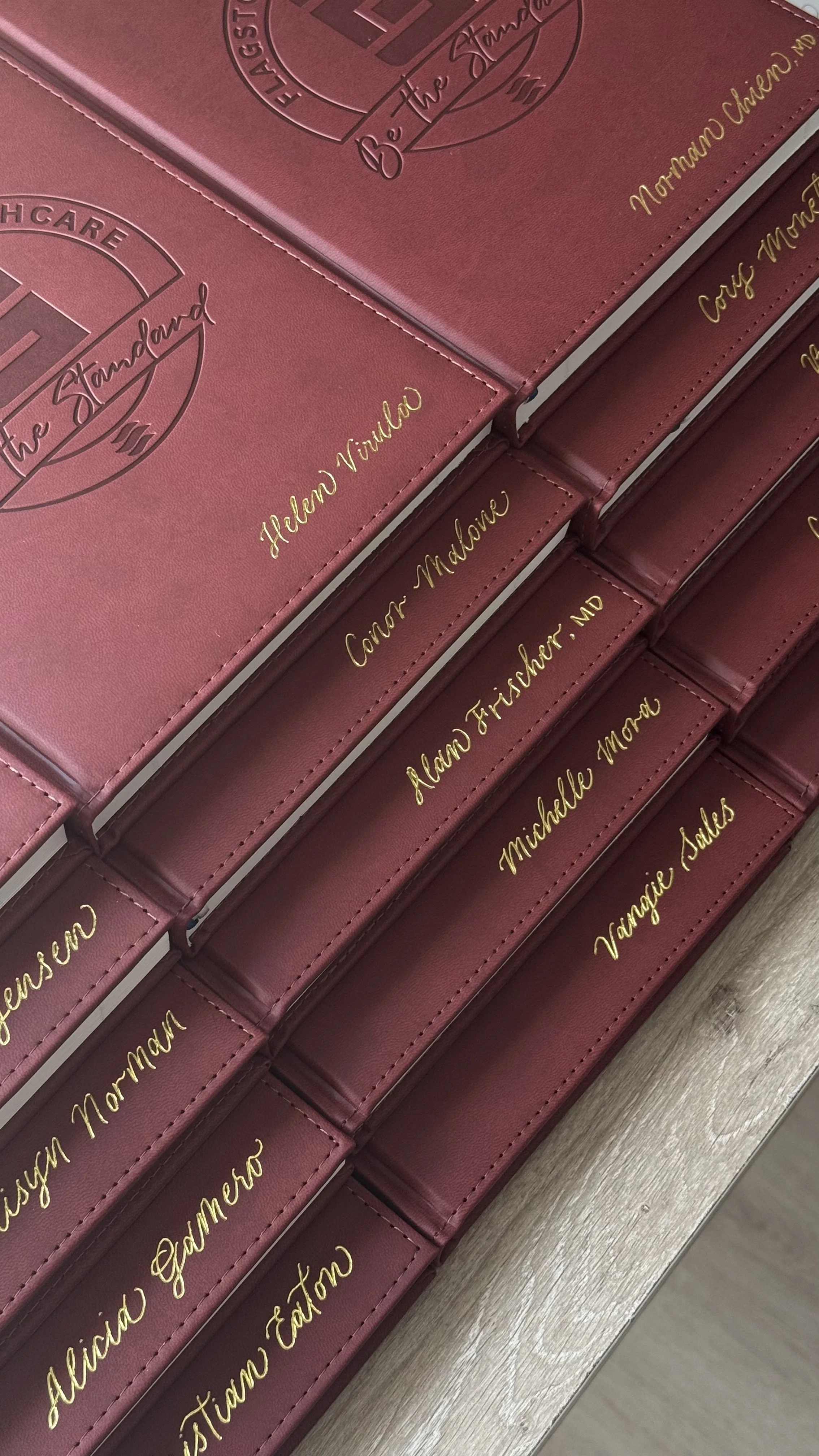 Gold hot foiling by hand on custom leather journals for Flagstone Healthcare doctors and nurses
