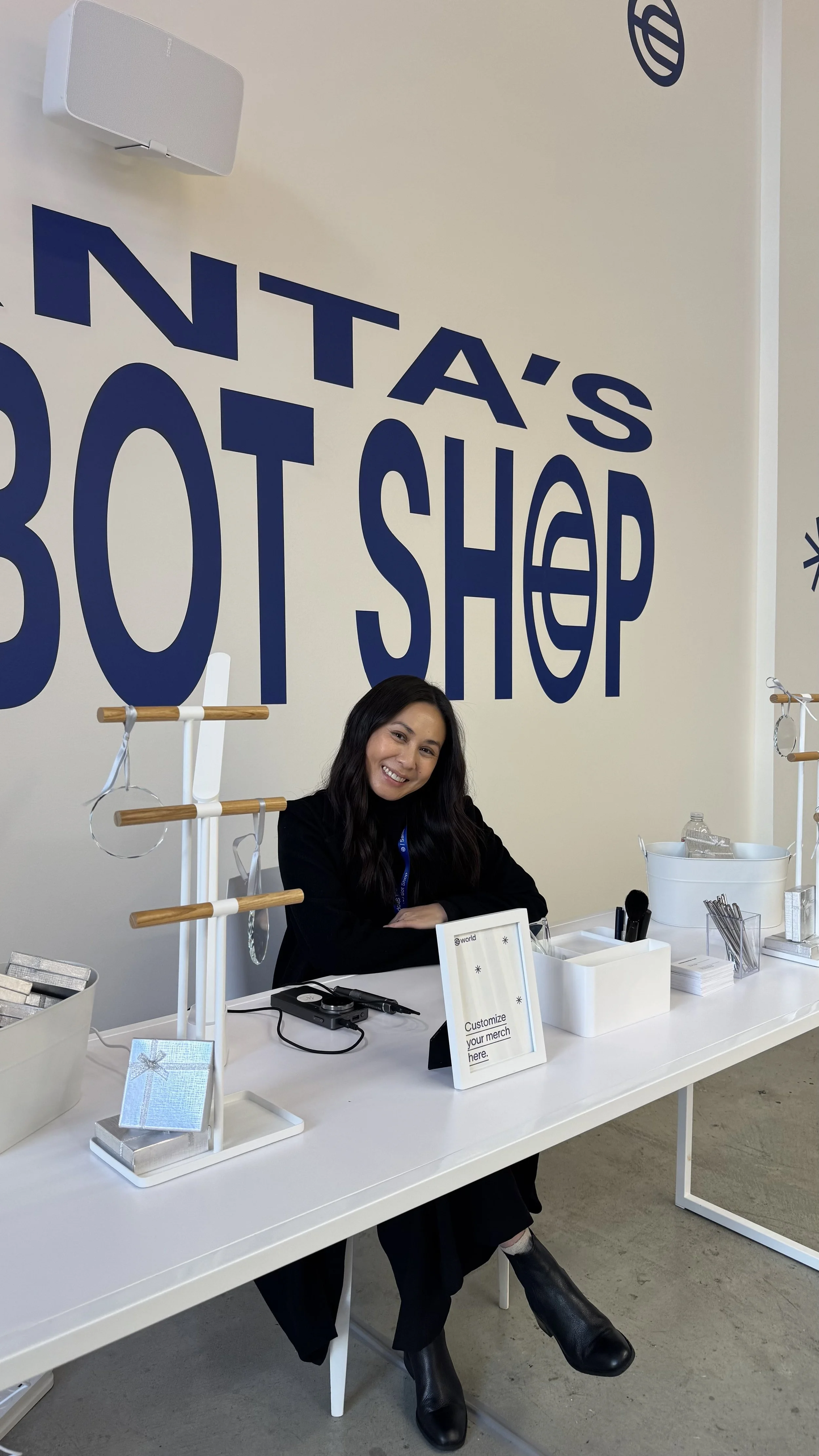 Stacy Shon engraving glass ornaments at the WORLD brand activation in Union Square San Francisco
