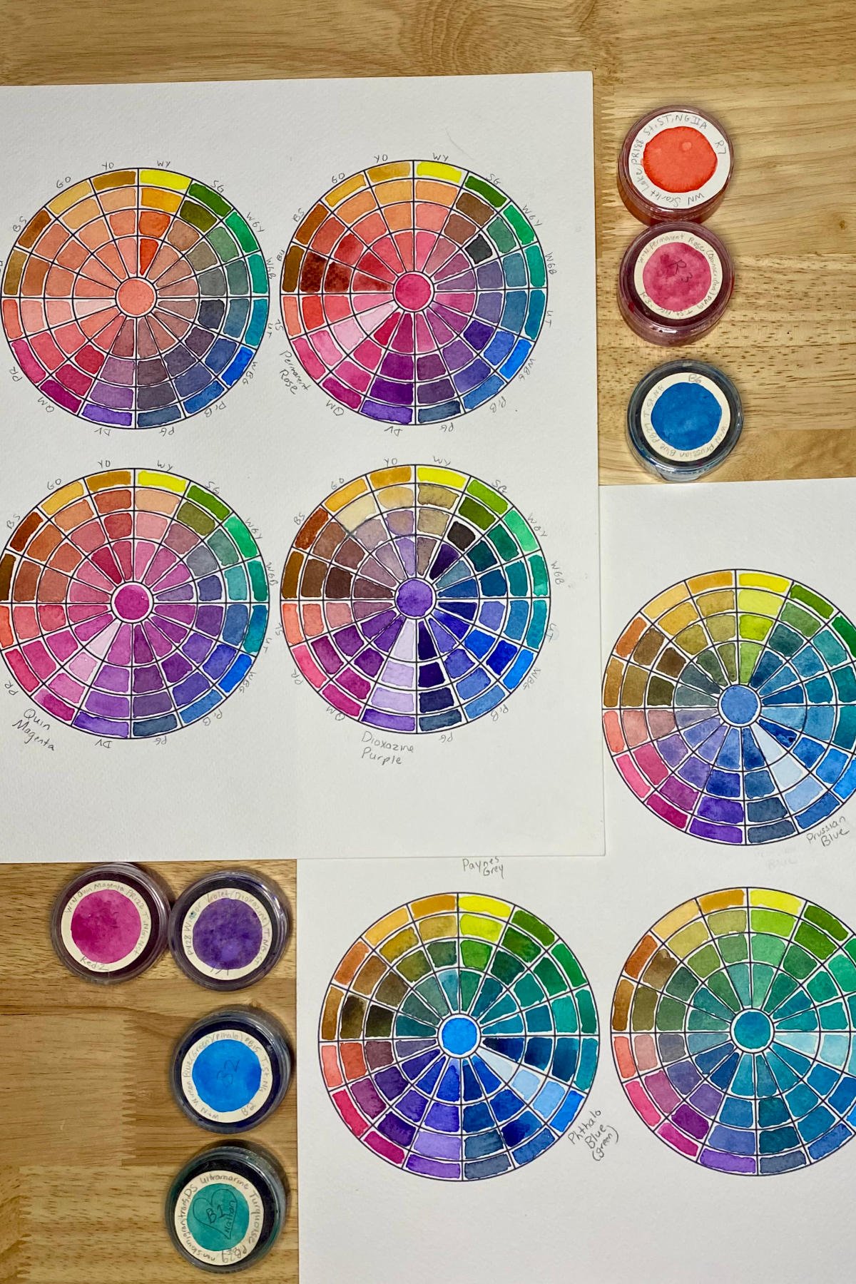 Examples of watercolor mixing charts which circle around one focal color, creating a color story