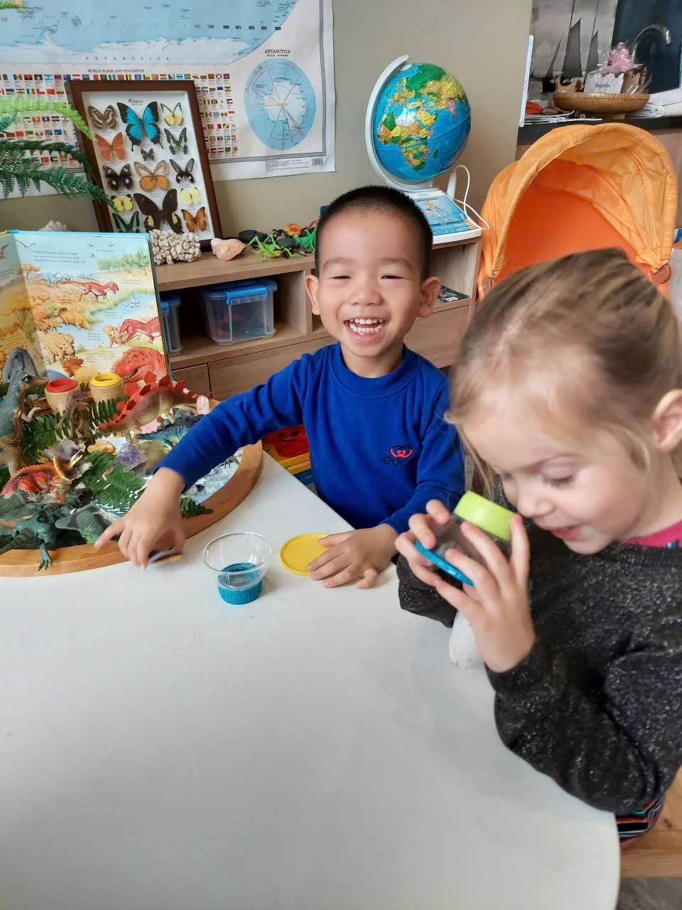 Chidren using their imagination to create artwork with flowers