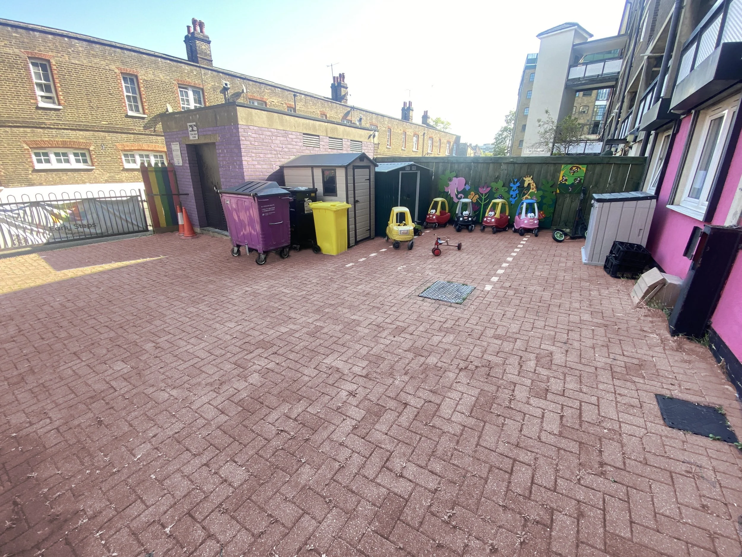 front garden car zone with tricycles and ride-on cars for active outdoor play