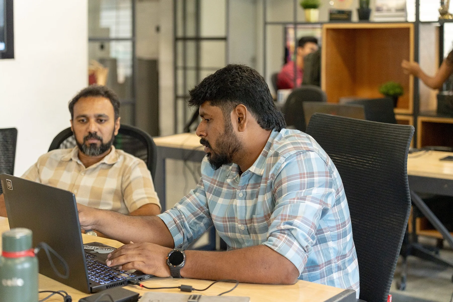 DVSI consultants reviewing project requirements and technical information during a collaborative consulting session in a modern office environment