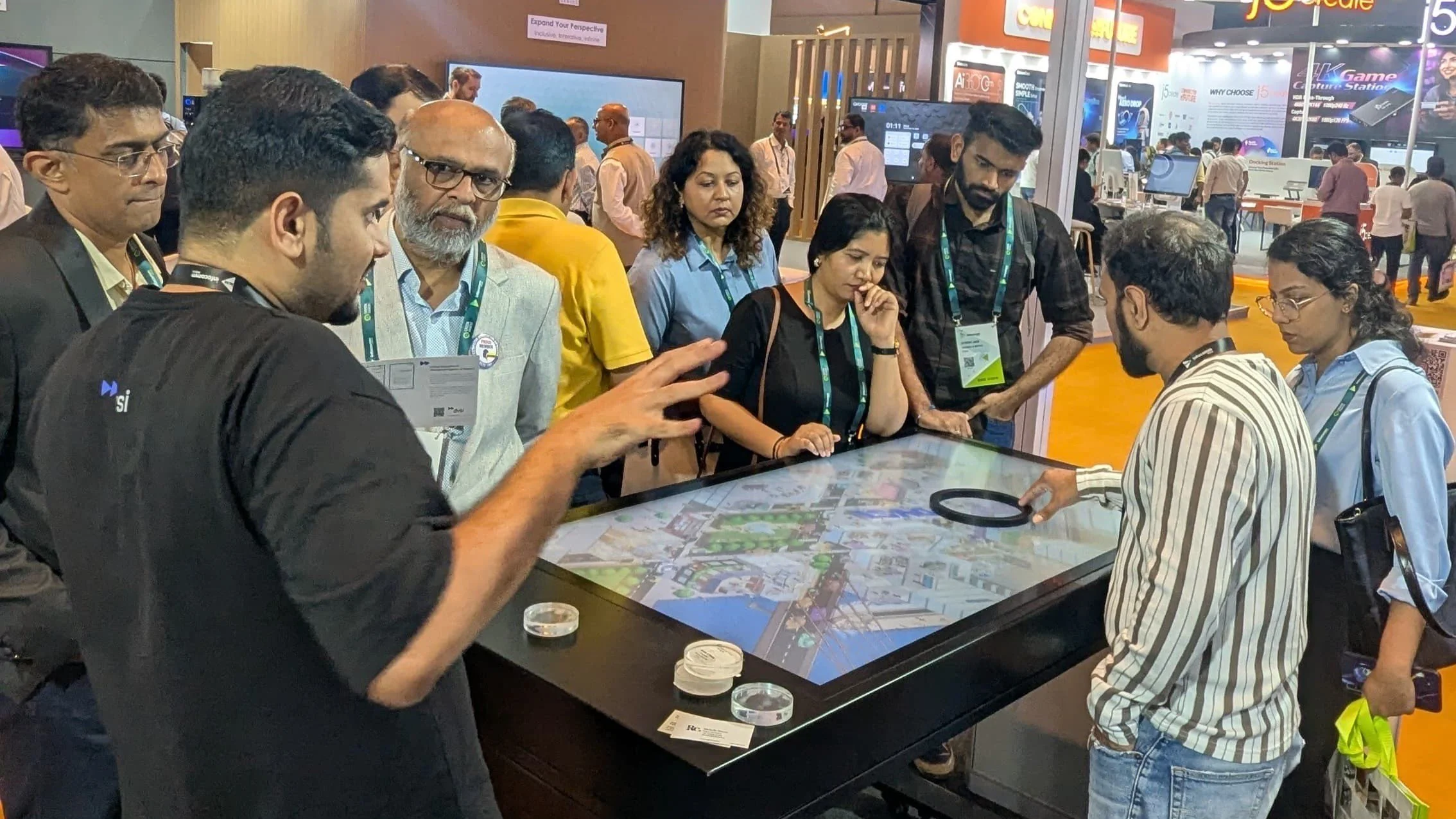 DVSI team demonstrating an interactive object recognition table to visitors within a corporate technology exhibition environment.