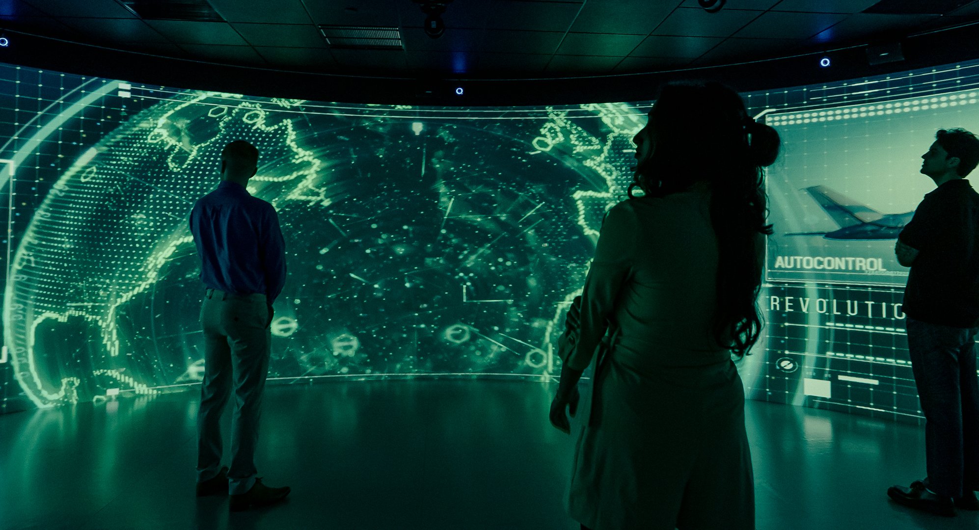 Visitors standing inside a 360 degree IGLOO dome environment experiencing large scale curved digital visualisation within a corporate experience centre designed by DVSI.
