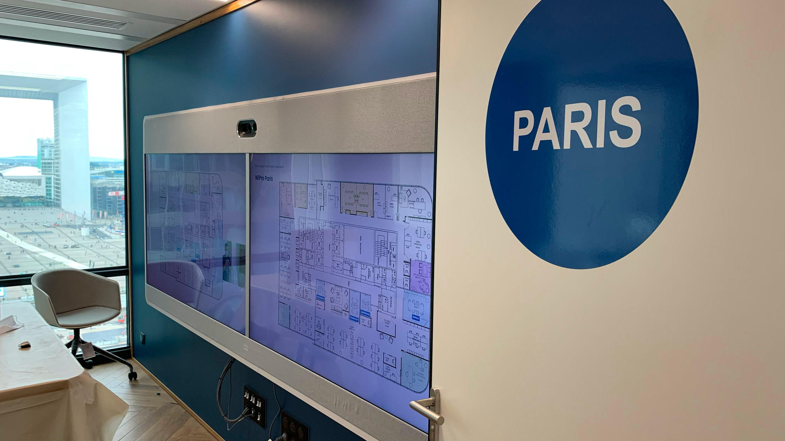 Executive collaboration space in Paris featuring large format interactive display for planning and decision making