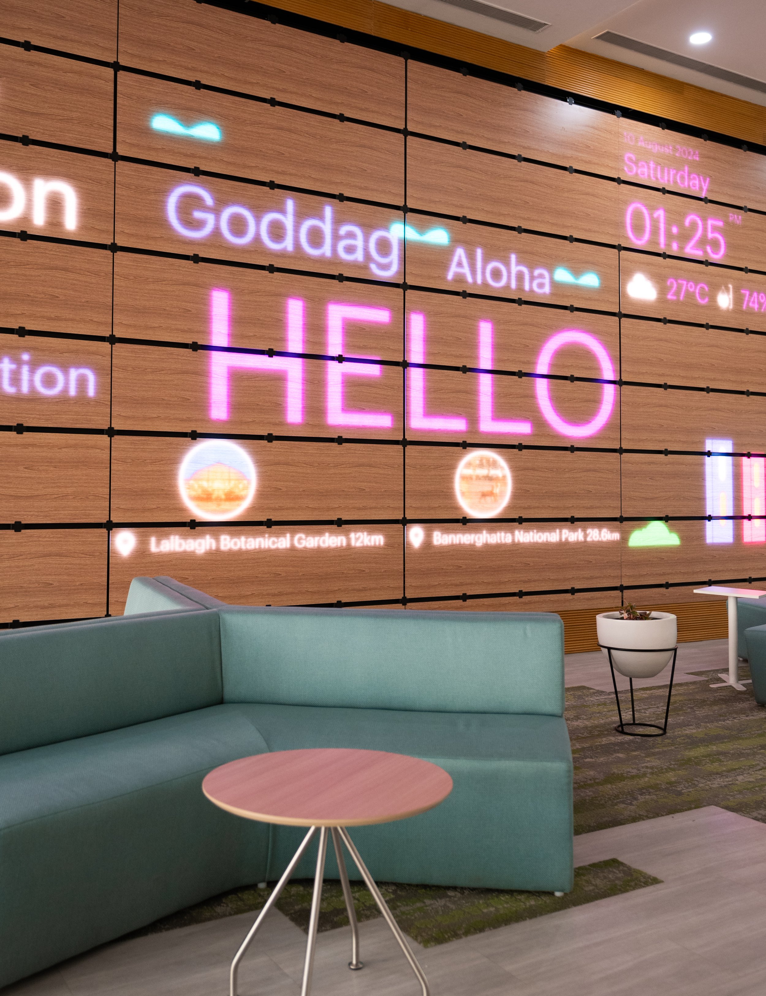 Veneer LED wall displaying dynamic welcome messages and real time information within a corporate lobby setting