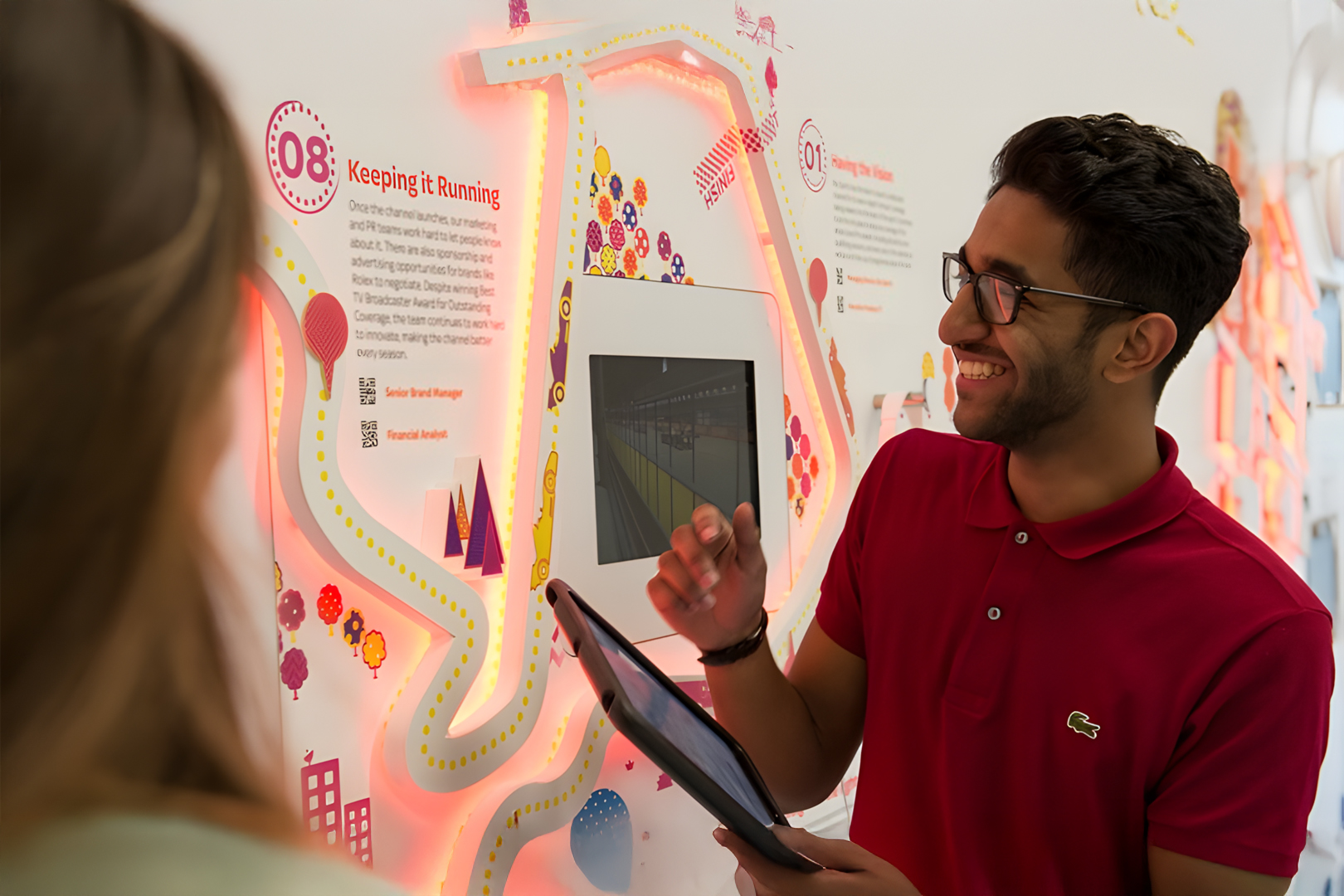 Visitor interacting with a digital journey wall using a tablet at the Sky Careers Lab experience
