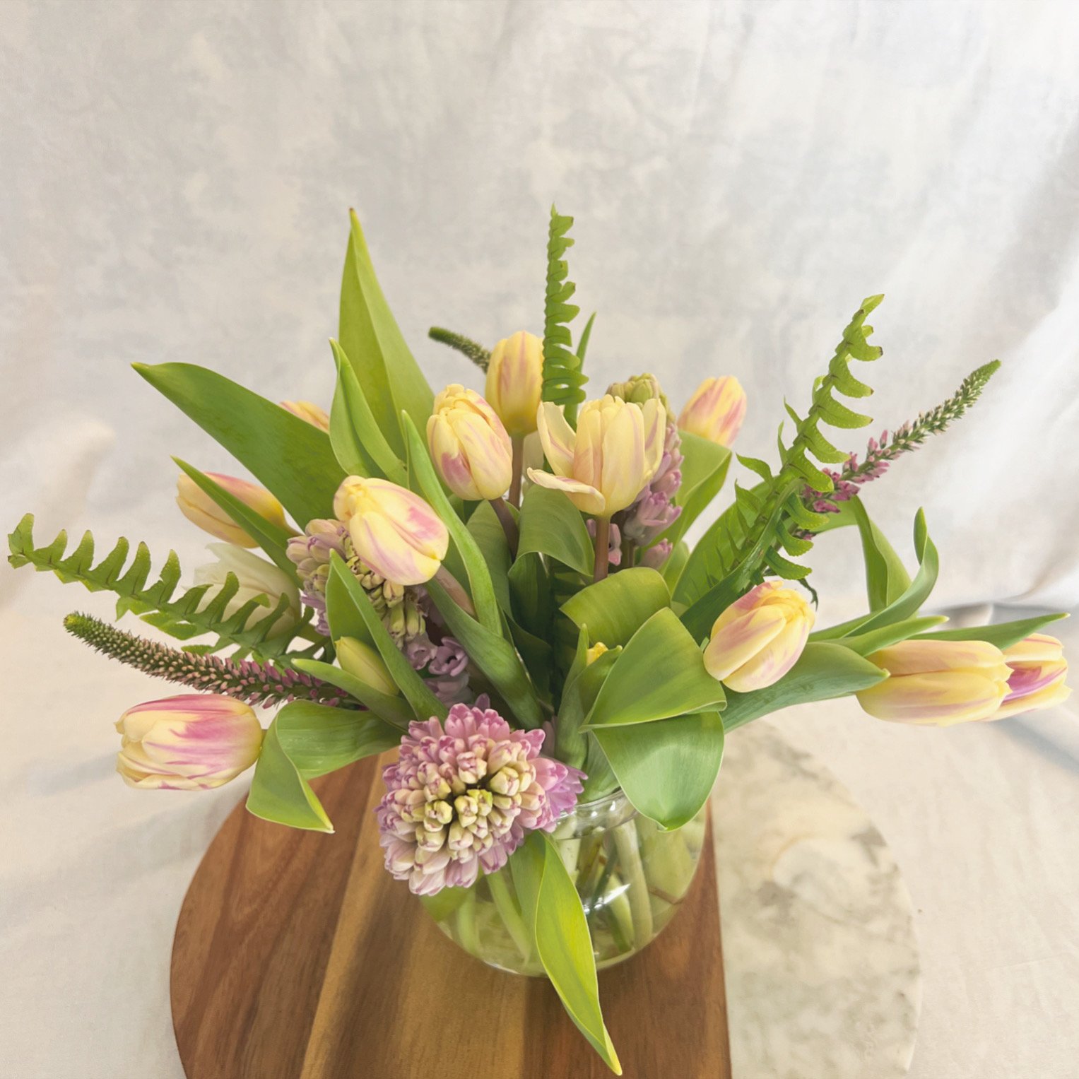 Fresh spring tulip arrangement in a clear vase from Meadow Edge Blooms, Columbia SC's premier florist.