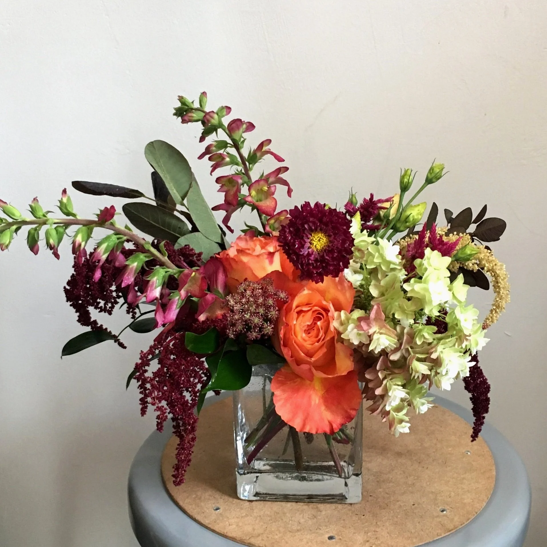 Gemstone Cascade flower arrangement at Meadow Edge Blooms, Columbia SC's top florist, featuring a vibrant palette of orange, red, purple, blue, and green for dynamic, eye-catching floral displays.