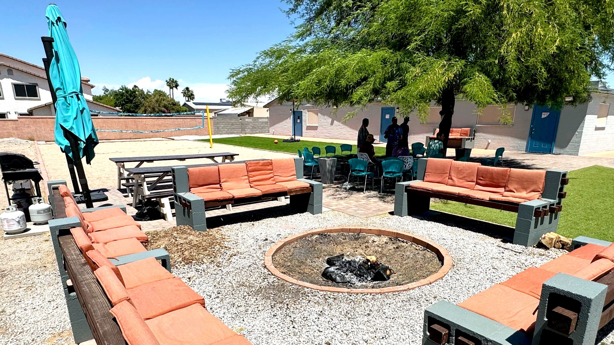 backyard seating with umbrella and fire pit