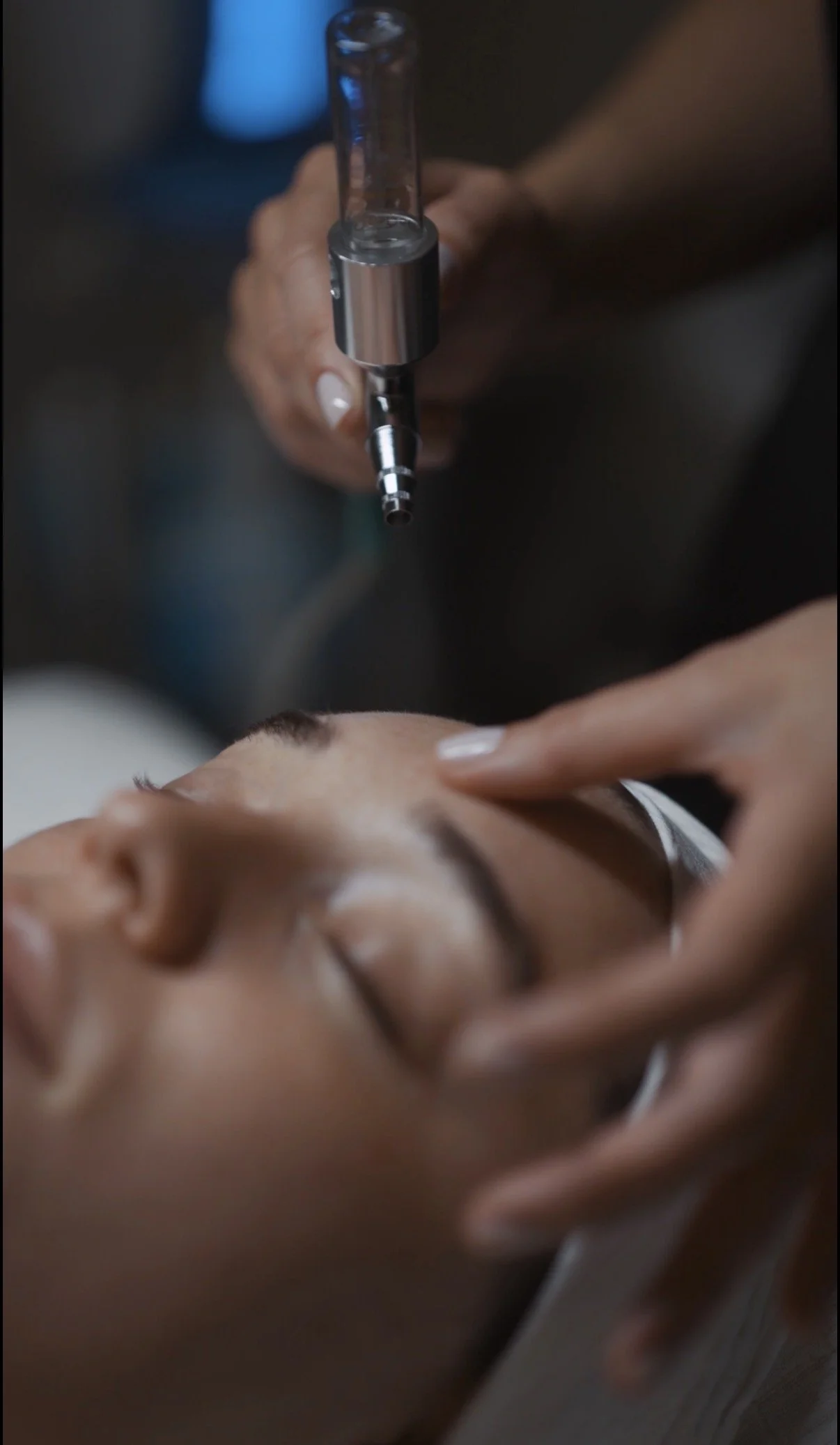 Oxygen treatment being performed on a client's face