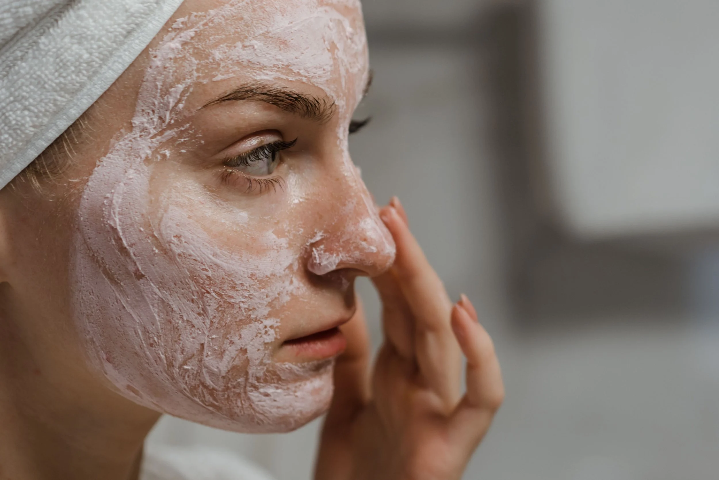 Woman exfoliating her face with a scrub