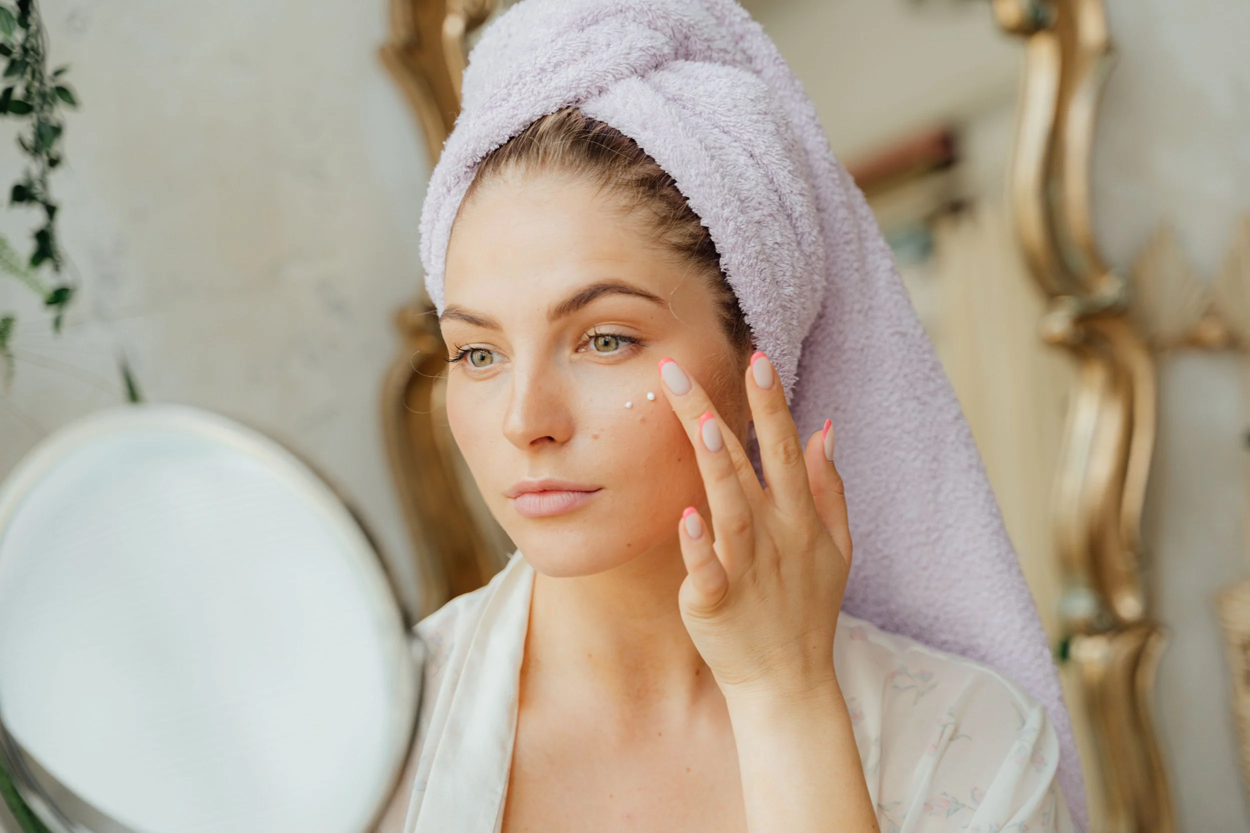 Woman applying retinol to her face