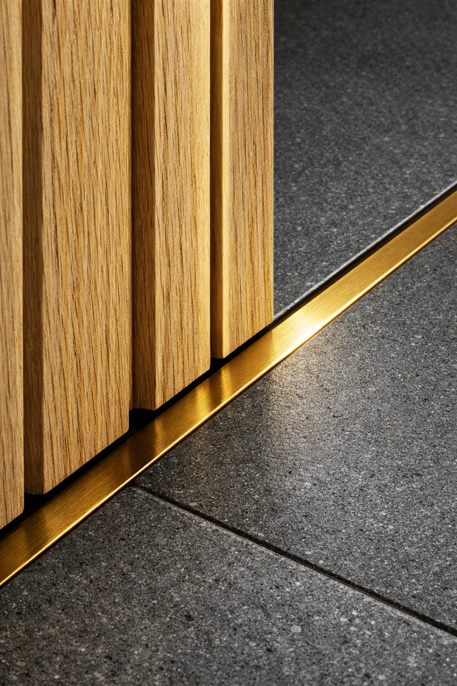 Detailed close-up of white oak slats, basalt stone flooring, and brass architectural finishes.