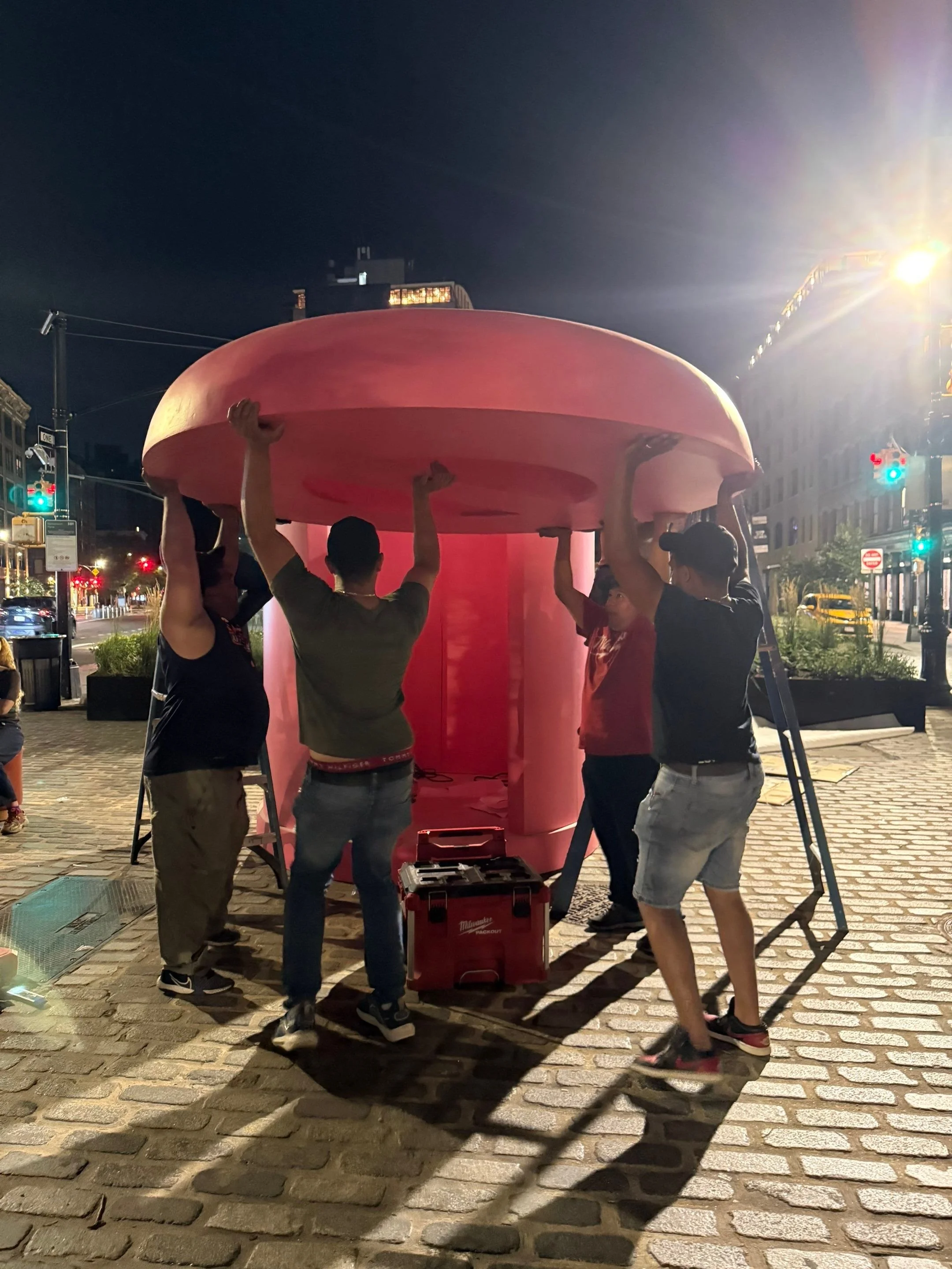 Four guys lifting the roof.