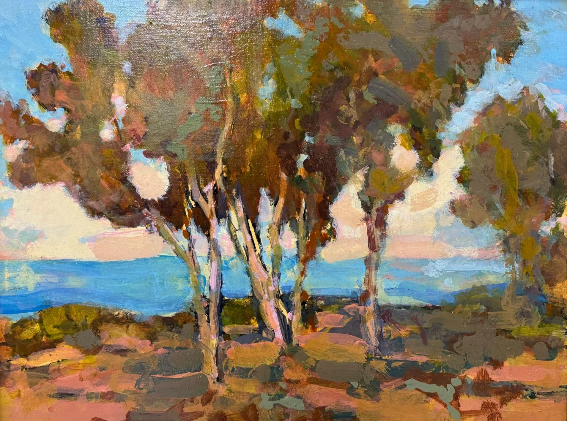 An impressionist-style landscape painting of a group of trees with colorful foliage against a blue sky, framed in a silver frame.