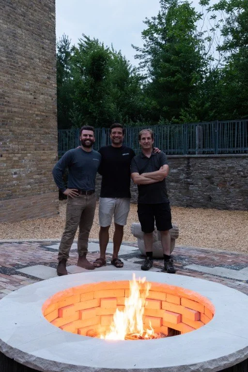 Johnson Playfair masons Sasha, Brendan, and Michael at their newly completed masonry pavilion and fire pit at Evergreen Brickworks in Toronto.