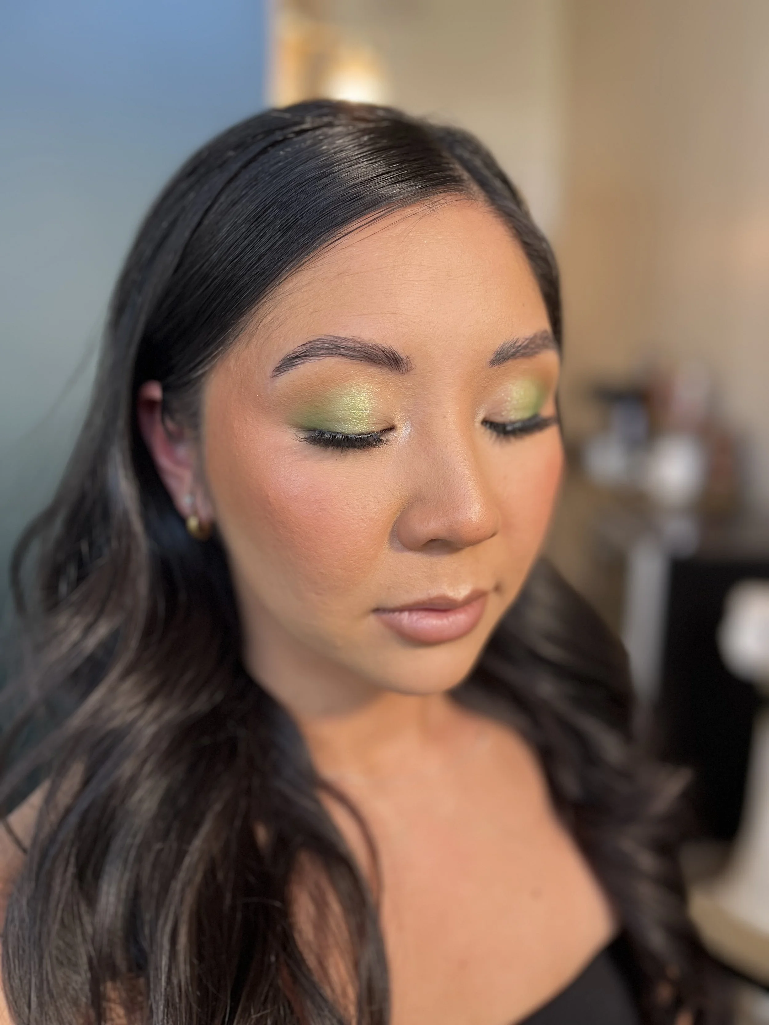 Asian Woman with a full glam fun makeup look, with lime green eye shadow blended beautifully with shimmers and transition colors. Makeup done by Erica K.