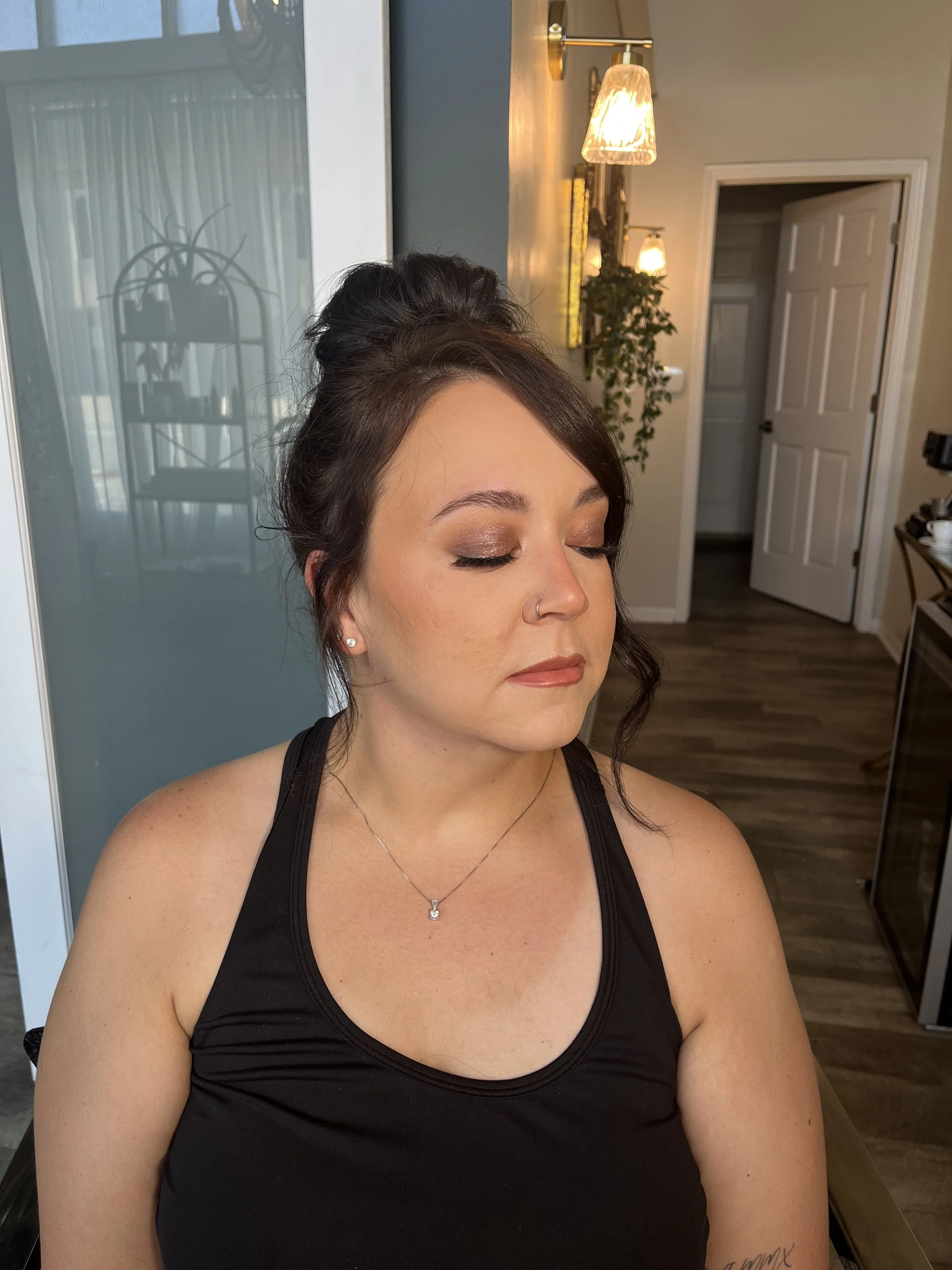 Caucasian woman who got a warm bronze makeup look with shimmers. Makeup done by Erica K.
