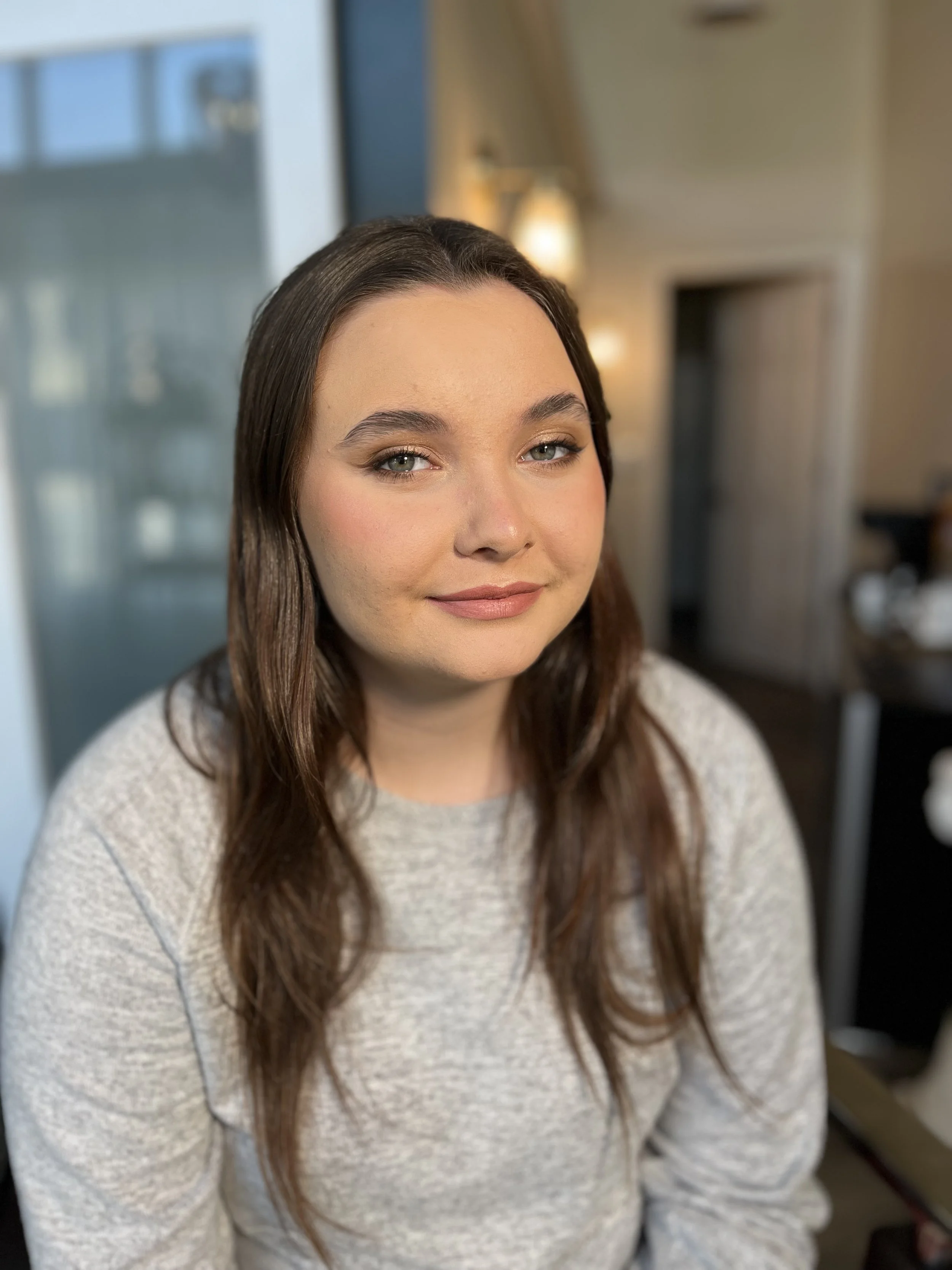 Young Caucasian woman with a soft glam makeup look and a winged eyeliner. makeup done by Erica K.