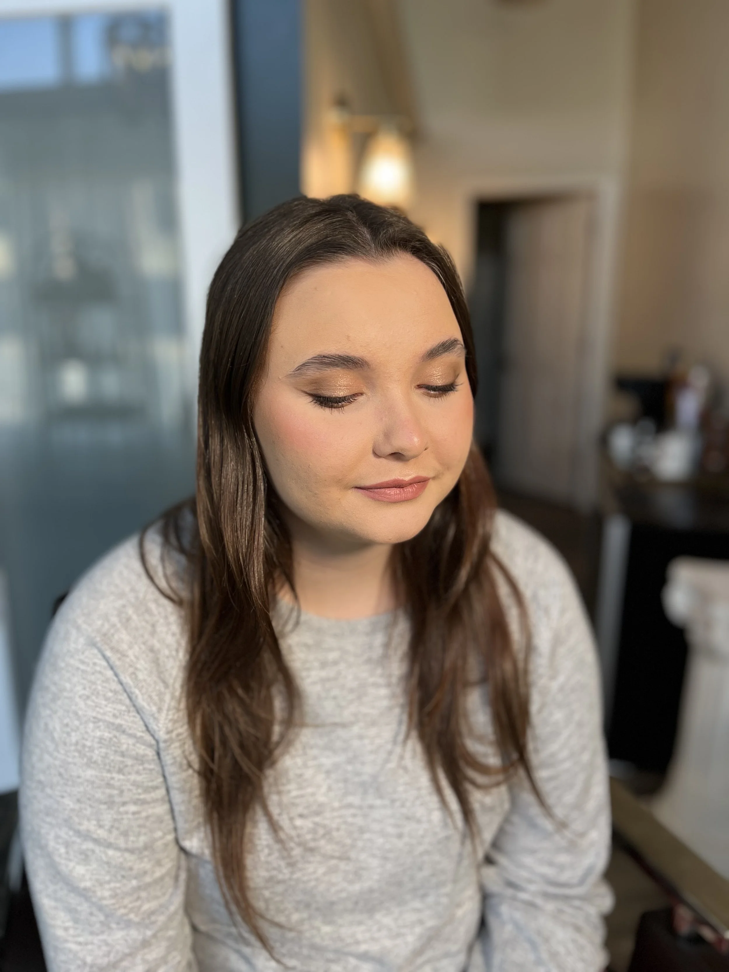 Young Caucasian woman with a soft glam makeup look and a winged eyeliner. makeup done by Erica K.