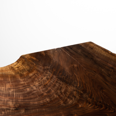 Close-up of a polished wooden surface with visible grain patterns.