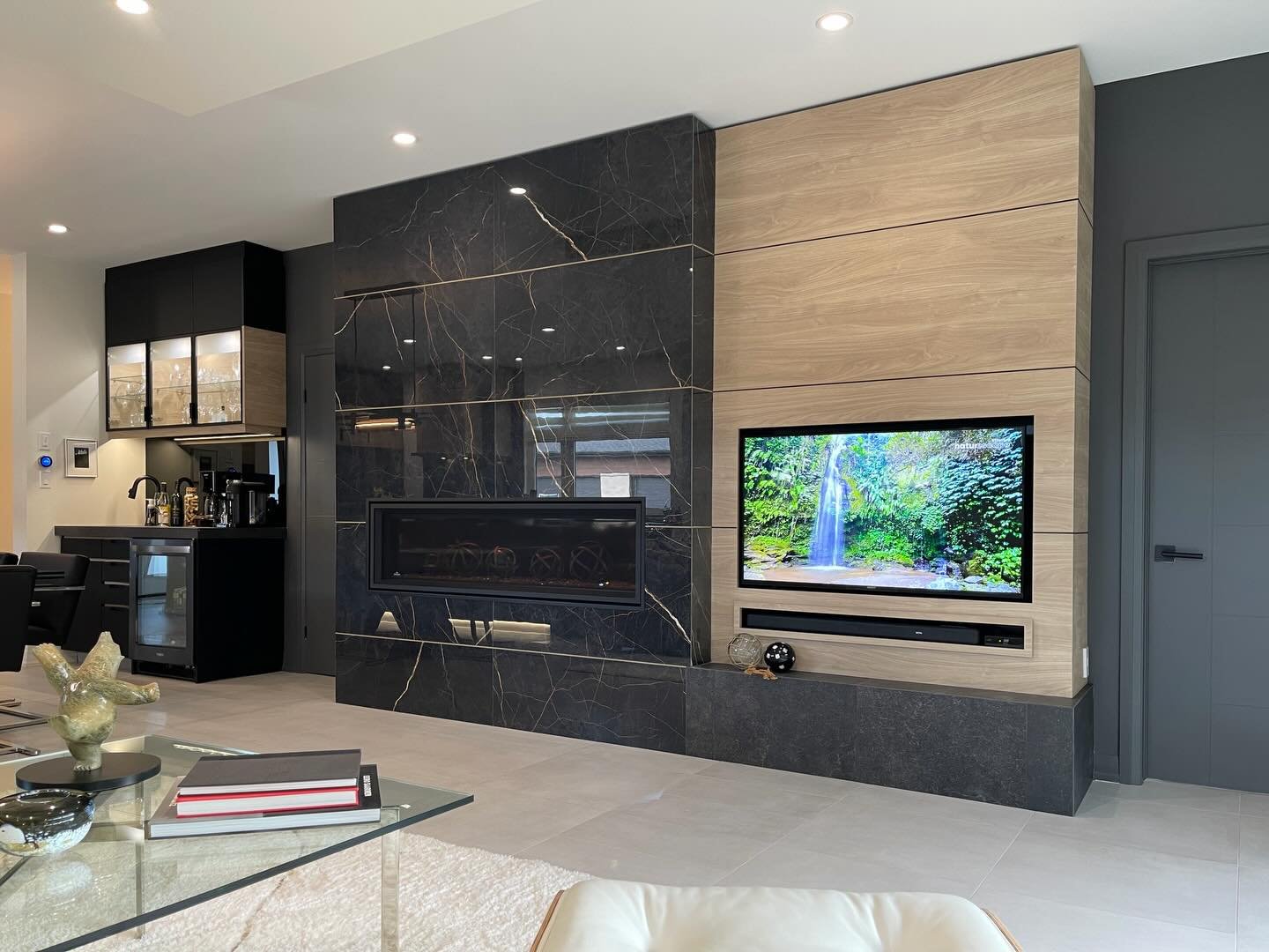 Wrapping up this Richmond Woods project with one of the main focal points of the home, the living space. A balance of warm wood tones and bold stone creates contrast while still keeping everything feeling cohesive and intentional. The fireplace wall 