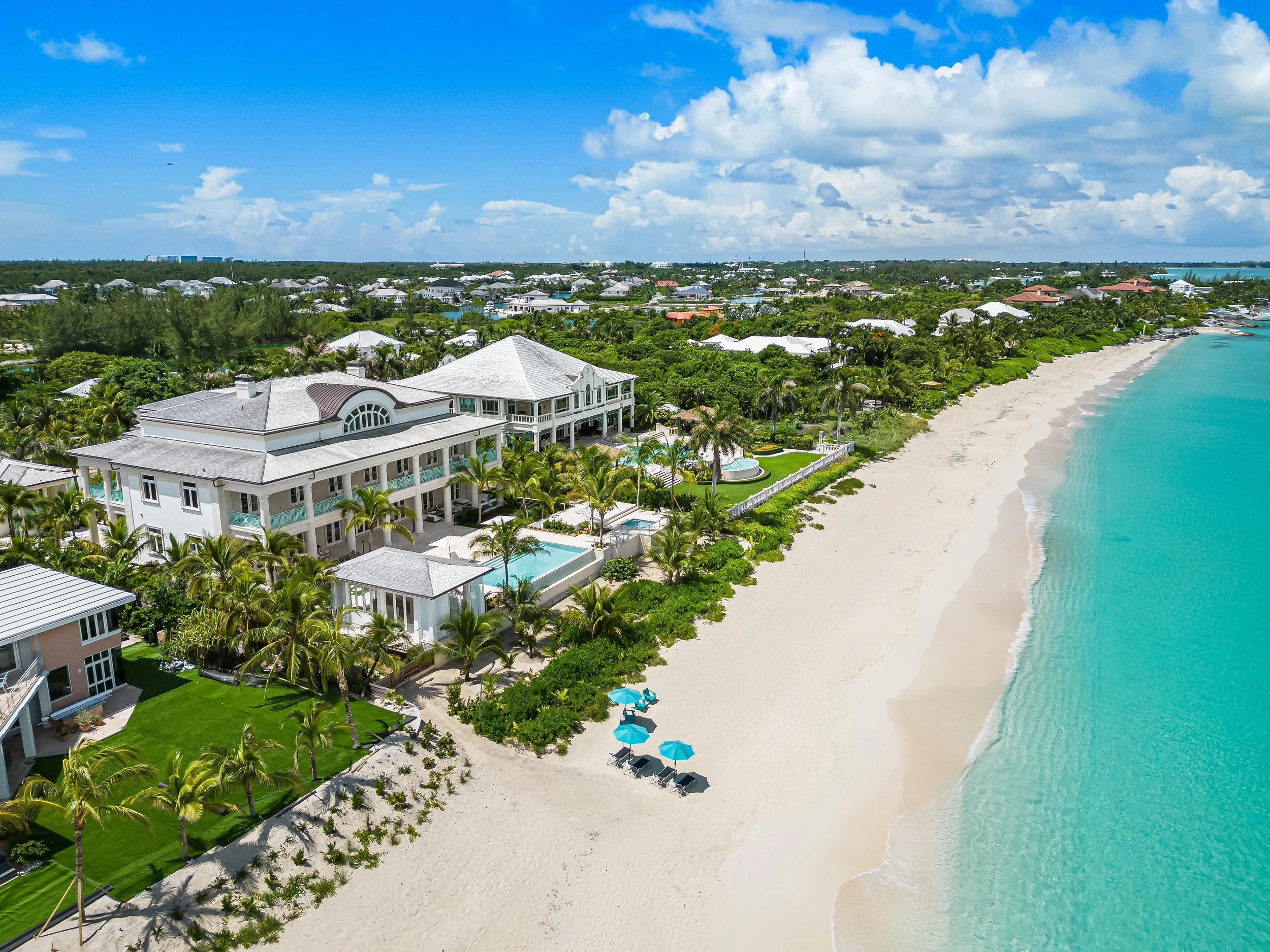 Stunning view of Water's Edge Villa sitting on the beach of Bahamas crystal blue water. - Water's Edge Villa