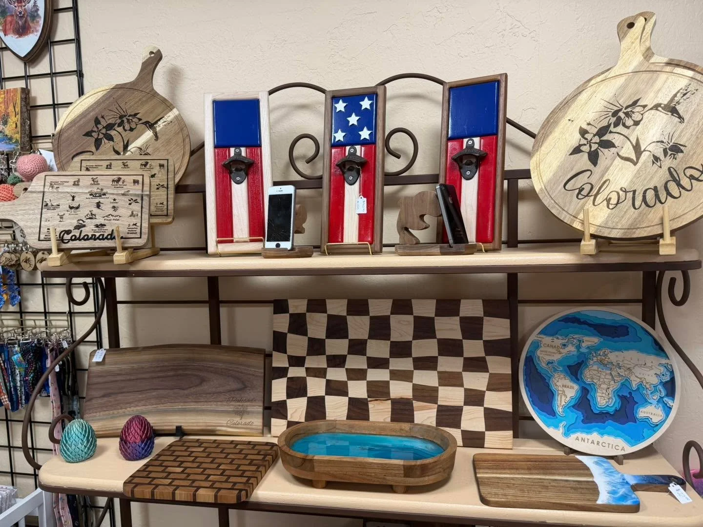 Can we take a minute to appreciate this shelf? 🙌

So much great woodwork in one spot. Engraved Colorado boards, flag bottle openers, phone stands, resin trays, and that layered world map we can&rsquo;t stop looking at.

Every piece has so much detai