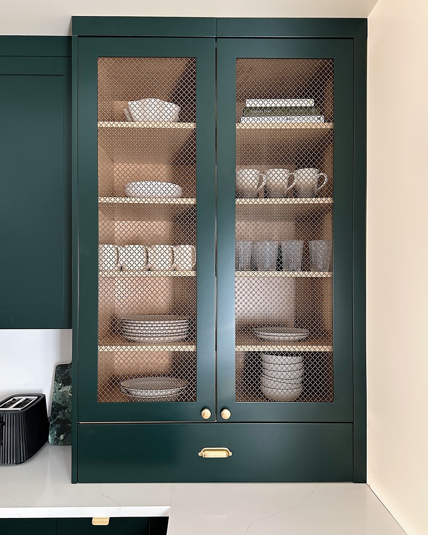 customization in every corner of our project at #heritage1855vine, we chose a custom colour for the cabinetry (essex green by benjamin moore) with aged brass rejuvenation hardware. we worked with @swedekitchens to cut out the centre of our cabinetry 