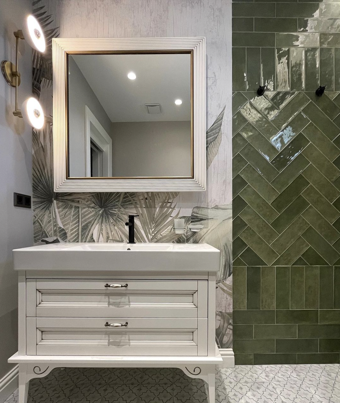 Eclectic bathroom with shower, white and light green base colours in floor and cabinet details, combined with a nature inspired wall paper and mediterranean style mixed patterned green wall tiles as an accent focal point.