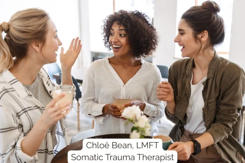 Three women in healthy connection having tea and conversation—representing how people-pleasing recovery  leads to balanced, reciprocal relationships. Somatic therapy helps women rebuild authentic connection  in Los Angeles and beyond.