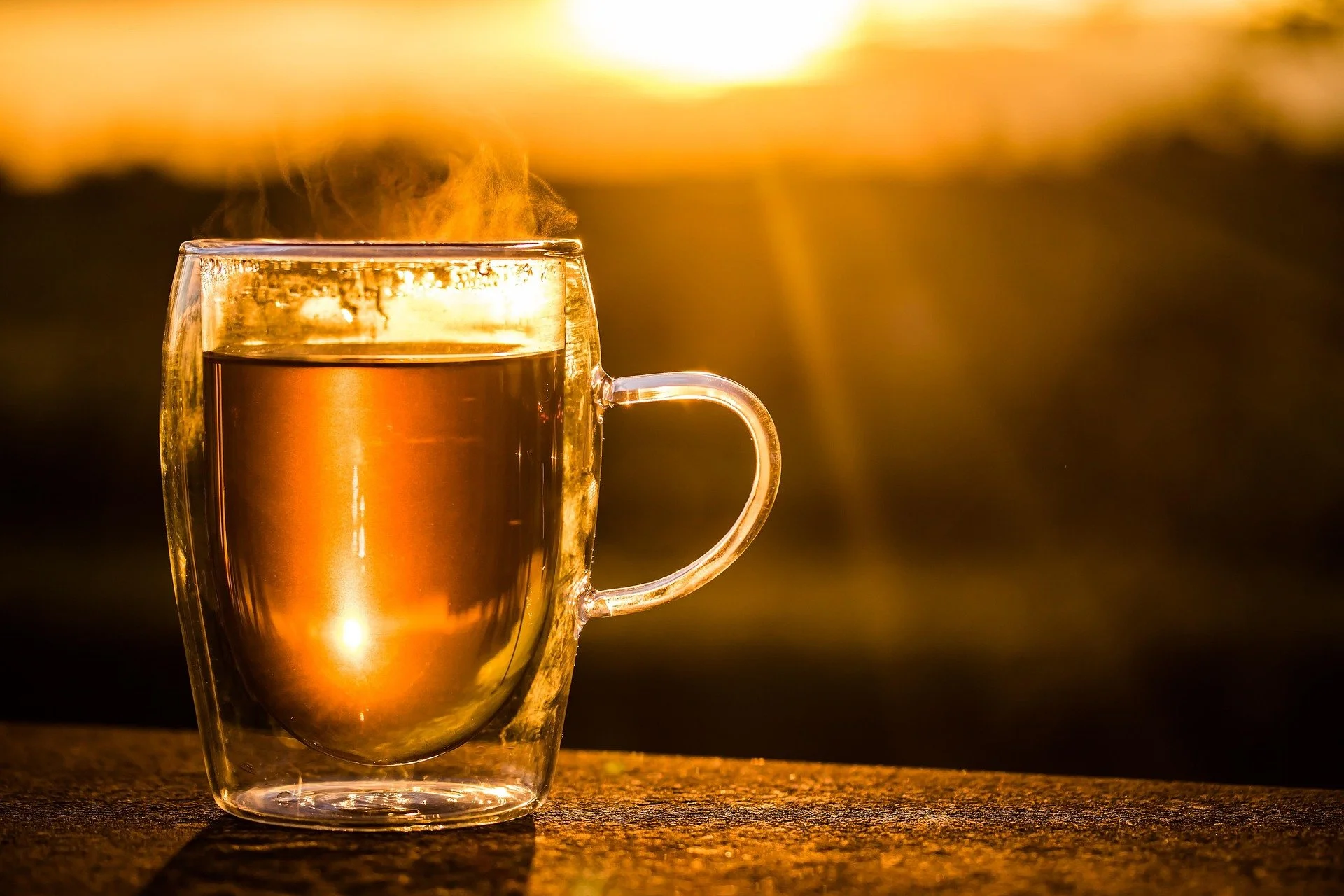 A cup of black tea in natural sunlight, illustrating a somatic nervous system reset for women navigating stress and life transitions.