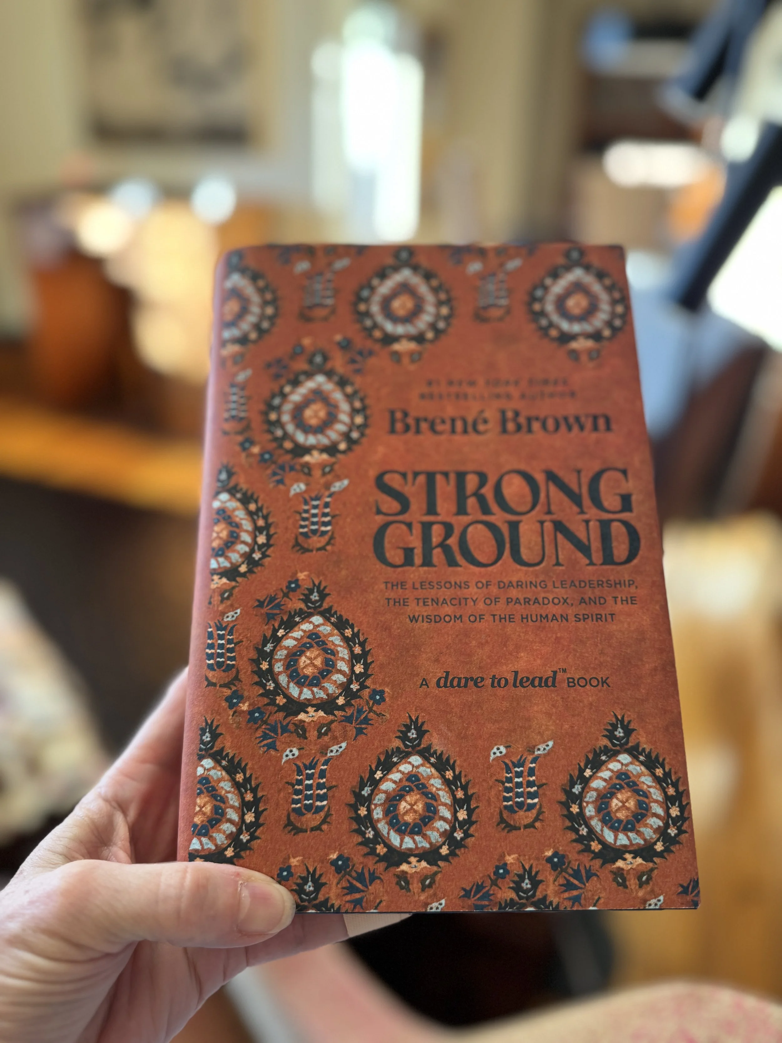 Book cover titled "Strong Ground by Brene Brown"