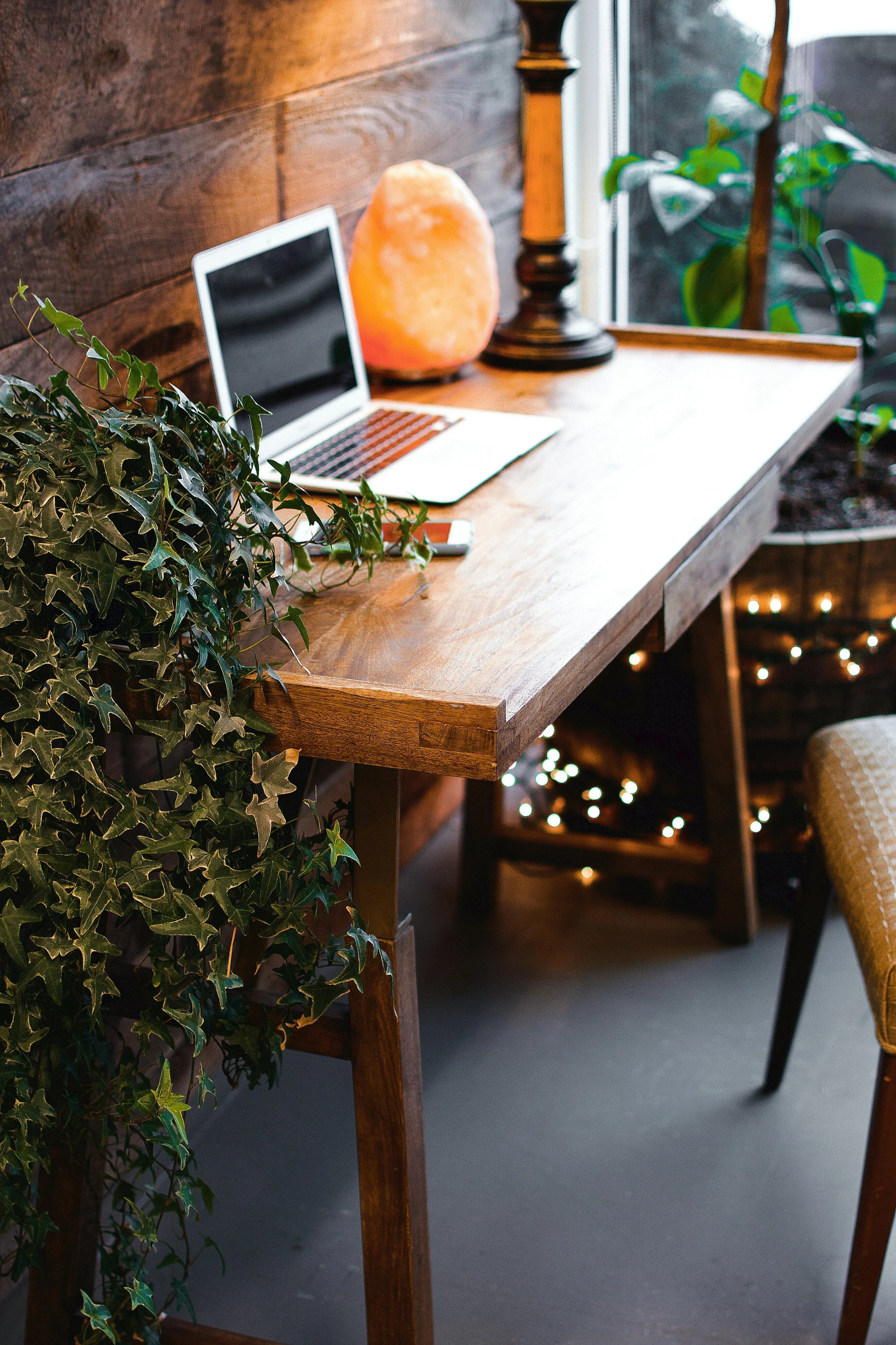 Laptop on wooden desk in a cozy cabin